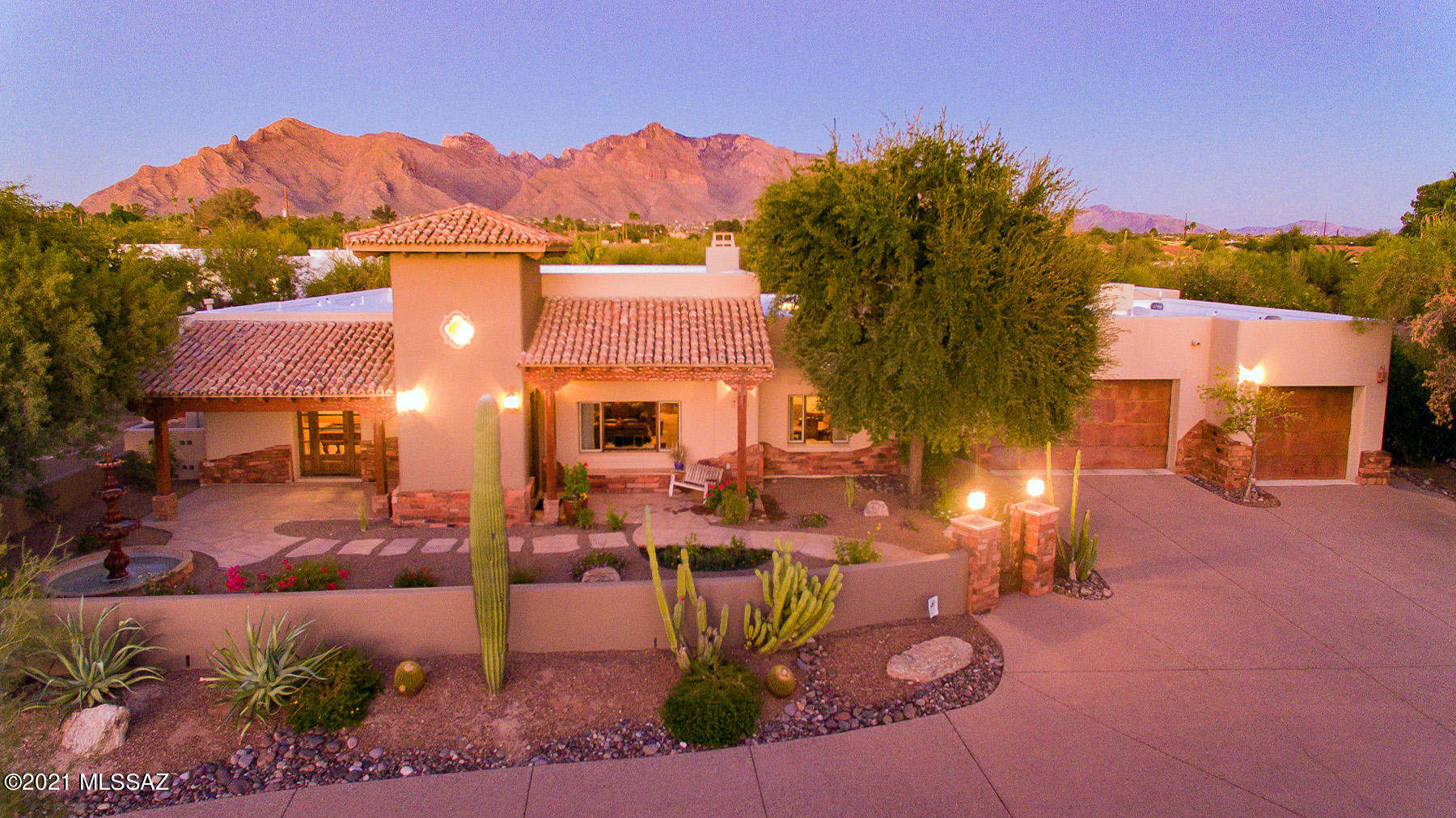 Absolutely stunning Hacienda/Territorial Style custom home with an amazing resort-like rear yard.  Nestled on a private 1.74 acre lot offering wonderful mountain views. Stunning great room with 14' high log beam ceilings, stack stone fireplace and large wet bar area.  Gourmet kitchen with Tuscan-style custom cabinetry, granite counters and SS appliances. Gorgeous natural stone and flagstone flooring throughout. Beautiful 8' knotty alder doors . Luxurious bathrooms. Separate office and billiards room. Amazing resort style pool, rock waterfall, ramada, outdoor kitchen, gardens, fireplace, flagstone patios and mountain views! See virtual tour, floor plan and features list in documents. Great north location near Oracle Rd and Orange Grove. MUST SEE More section for EXTENSIVE feature list. Large Billiard Rm could become 4th Bedroom.
Roof to be service by Hallmark Roofing with warranty.
GENERAL
" Hacienda/Territorial Style home
" Frame and stucco exterior walls with real quarry stone decorative wainscotting
" Hand-hewn patio posts and beams
" Old-world style clay roof tiles
" Dramatic unobstructed backyard Catalina Mountain views
" Nearly two-acre property with lush desert trees and cactus surrounding perimeter of
patio/courtyard walls
" Dual-glazed insulated windows
" Two zone air conditioning and heating
" Pre-wired alarm system
" Central vacuum system
" 8 Ft. solid wood panel knotty alder interior doors
" Hawk and trowel interior walls with custom plaster-look paint finish
" Custom hand-distressed alder hardwood floors combined with beautiful flagstone
floors in general common spaces
KITCHEN
" Tuscan-style custom cabinetry
" Granite countertops
" Double undermount stainless steel sink
" Center island with undermount stainless steel prep sink
" Dacor Epicurean 36" 6-burner gas range with electric oven
" Dacor wall oven and microwave oven
" Dacor warming drawer
" Bosch dishwasher
" Built-in Sub-Zero refrigerator/freezer
" Double trash pull-out
" Large walk-in pantry with adjustable shelving system
" Kitchen opens to morning room/casual dining room with beautiful Catalina
Mountain views
" Immediate access to kitchen from garage with convenient drop spot area
FORMAL DINING ROOM
" Intimate dining room o< kitchen
" Window view of Tucson Mountain views/sunsets
" Co<ered ceiling
FOYER
" 8 Ft. knotty alder front door with glass side lights
" 20 Ft. ceiling with exposed wood beams and shiplap
" Arabesque clerestory windows
" Dramatic weathered-look faux painted walls
" Deep archway leading into great room
GREAT ROOM
" Stunning 14+ ft. ceiling with large log beams spaced between barrel arches
" Large picture windows framing back yard resort-look pool with Catalina Mountains
backdrop
" Large window with Tucson Mountain views/sunsets
" Walk-in sunken wet bar area with sit down seating facing back yard/mountain views
" Wet bar with stainless steel sink, under cabinet refrigerator and granite countertops
" Gorgeous feature wall with stacked stone fireplace, rustic wood mantel, built in
TV/media area, and decorative niches with accent lights
" Oversize room with flagstone floors and inset carpet area for TV viewing/lounging
area
BILLIARD ROOM
" Pool table room open to great room
" Low pony wall accented with large wood carved columns with corbels
" Two artwork niches
" French door with 2 operable sidelights opening out to private patio with water
fountain feature and Tucson Mountain views/sunsets
MASTER BEDROOM
" Oversized bedroom with back yard and Catalina Mountain views
" French door with access to back yard
" Floating built-in nightstands with under cabinet lights (accommodates king size
bed)
" Bedside wall sconces
" Built-in wall niches above bed area with lights
" Built-in surround-sound speakers
MASTER ENSUITE
" Oversized bath area
" Two separate His and Hers sink vanities with under cabinet lights
" Natural stone floors
" Built-in oversized heated spa tub
" Large steam shower with seat and dual shower head and hand-held head
" Spacious walk-in closet with His and Hers custom closet system
GUEST BEDROOM 1
" Spacious bedroom area
" Ensuite bath with shower and large vanity
" Walk-in closet with closet system shelving
GUEST BEDROOM 2
" Spacious bedroom area
" Walk-in closet with closet system shelving
" Double French door access to back yard patio
HALL BATH
" Full bath with tub and shower
" Spacious vanity with pool towel cabinet
" French door access to backyard patio/pool area
LAUNDRY/CRAFT ROOM
" Oversized, space for extra refrigerator
" Desk height cabinetry one side for sewing and crafts
" Opposite side 36" H cabinets with deep laundry sink
" Built-in electric ironing board
OFFICE
" Built-in o<ice cabinetry with his and hers seating/workspaces
" Wrap around laminate countertops
" Three tall cabinets with 4 file drawer stacks each with storage above
" Large window with backyard/mountain views
BACK YARD OASIS
" Resort-style pool featuring rock formation swim-through waterfall grotto and large
shallow beach area
" Oversized porch areas o< main house with beautiful hand-hewn wood pillars
" Large party ramada
Ø Outdoor kitchen/barbeque/sink
Ø Large peninsula with counter-height slate countertop
Ø Ample seating areas for entertaining and lounging
Ø Wood burning fireplace
" Discriminating expanse of flagstone at back porches, ramada, pool decking and
walkways
" Four ceiling fans at back porch and ramada
" Grass beyond pool and in front of ramada providing cool relaxing green space
" Succulent garden, flower planter, rose garden and vegetable garden areas
" Stunning backdrop of Catalina Mountains with saguaro cactus in foreground
" Mature palm trees, shade trees and citrus trees (tangelo, orange, lemon, lime,
grapefruit)
FRONT OUTDOOR FEATURES
" Courtyard with patio walls and gated entry
" Covered porches on each side of the entry/foyer turret
" Flagstone walk-ways and porch floors
" Round triple-tiered water fountain
" Xeriscape landscape plants
" Expansive aggregate concrete circular driveway
" Circular landscape area full of mature saguaro cactus
" Beautiful Tucson Mountain sunset views
GARAGE
" Oversized garage accommodating up to four cars
" Beautiful rustic metal garage doors with smart garage door openers
" Built-in workbench and ample garage storage cabinets