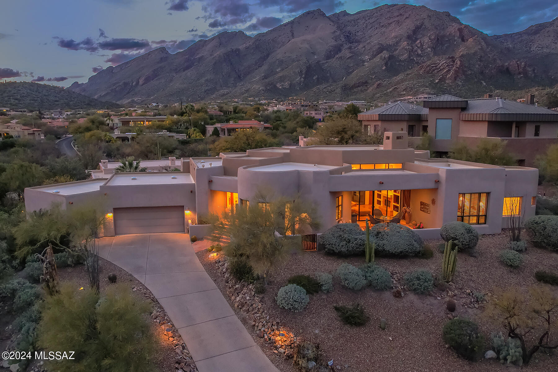 Nestled within the exclusive gated enclave of The Ridge at Ventana, this exquisite 3,122 sq. ft. custom home presents a perfect blend of luxury and comfort. Crafted with precision by Mark Allen, this 4-bedroom, 3-bathroom residence embodies the essence of southwest contemporary design. Its open floor plan, accentuated by saltillo floors and vaulted ceilings, effortlessly merges with an abundance of natural light to create an inviting atmosphere.

The heart of this home is its chef's kitchen, which features stainless steel appliances, a generous dining area, and a central island, making it ideal for both casual family meals and sophisticated entertaining. The living room, anchored by a charming fireplace, offers a cozy retreat with stunning views that stretch from the Catalina