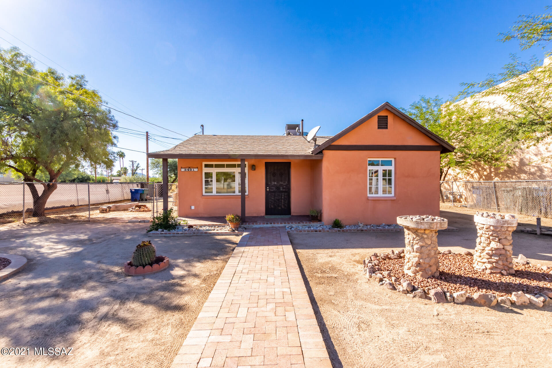 Excellent Property! Well Maintained Corner lot. Solid build & nice low maintenance landscaped desert front yard.  Paver pathway. Close to UofA & Banner Hospital.  Great Central Location, boasting a welcoming living room filled w/natural light, neutral tile flooring, & soothing palette. Eat-in kitchen boasts glass door cupboards, oak cabinetry, built-in appliances, & a peninsula w/breakfast bar that adds to the counter space. Sizable bedrooms w/closets.  Energy efficient dual pain windows. Backyard offers a covered patio w/extended eating area & fire pit. Front & back brick paver covered porches. Front porch has beautiful mountain views. Convenient storage shed & lots of potential to personalize. Vehicle access to the back yard with RV parking and concrete picnic pad. Brand New water heater