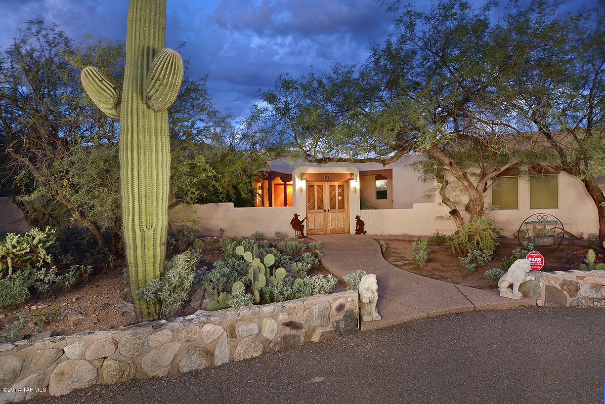 Outstanding Santa Fe style home on rare, 3.8 acre lot in the Catalina Foothills near Sabino Canyon. Appraised at $765,000. Home offers much privacy, views and lush desert landscaping. Courtyard with saguaro ribbed front gate and fountain leads into southwestern style home with soaring viga beamed and planked ceilings, neutral ceramic tile and carpet flooring, walls of windows, terrific Catalina Mtn views, fireplaces in family room, master and patio, gourmet kitchen/family room with granite counters, breakfast bar, beehive fireplace with bancos and niches. Gracious master suite offers office with sitting room, spa tub, two-way fireplace, travertine surrounds and accents. Expansive rear porch features flagstone floors, viga beamed and planked ceiling, District 16 schools
