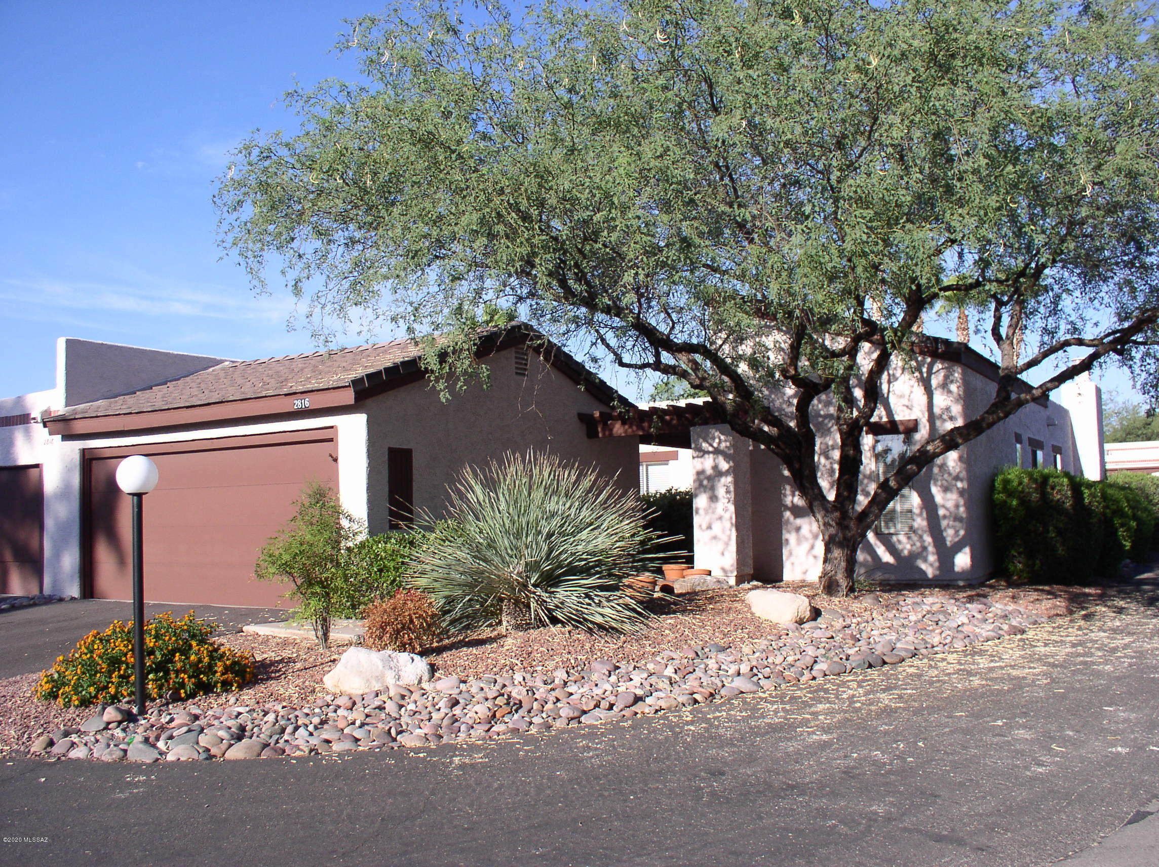 Formal living & dining rooms w/wooden shutters & high ceiling. Kitchen w/2 pantries, granite counter tops & opens to family room w/fireplace. Split bedroom plan all w/walk-in closets, master bedroom & family room opens to brick patio  & community pool. Ceramic tile floors through out w/carpet in bedrooms.  Double car garage w/storage room. Home is located on a corner lot. Close to shopping, restaurants, Banner Hospital, Trader Joes & St. Phillips Plaza.  Run, walk or cycle to River Walk Loop Trail, Tucson Racquet & Fitness Club & Rio Vista Park. Owner/Agent pays HOA Fees.