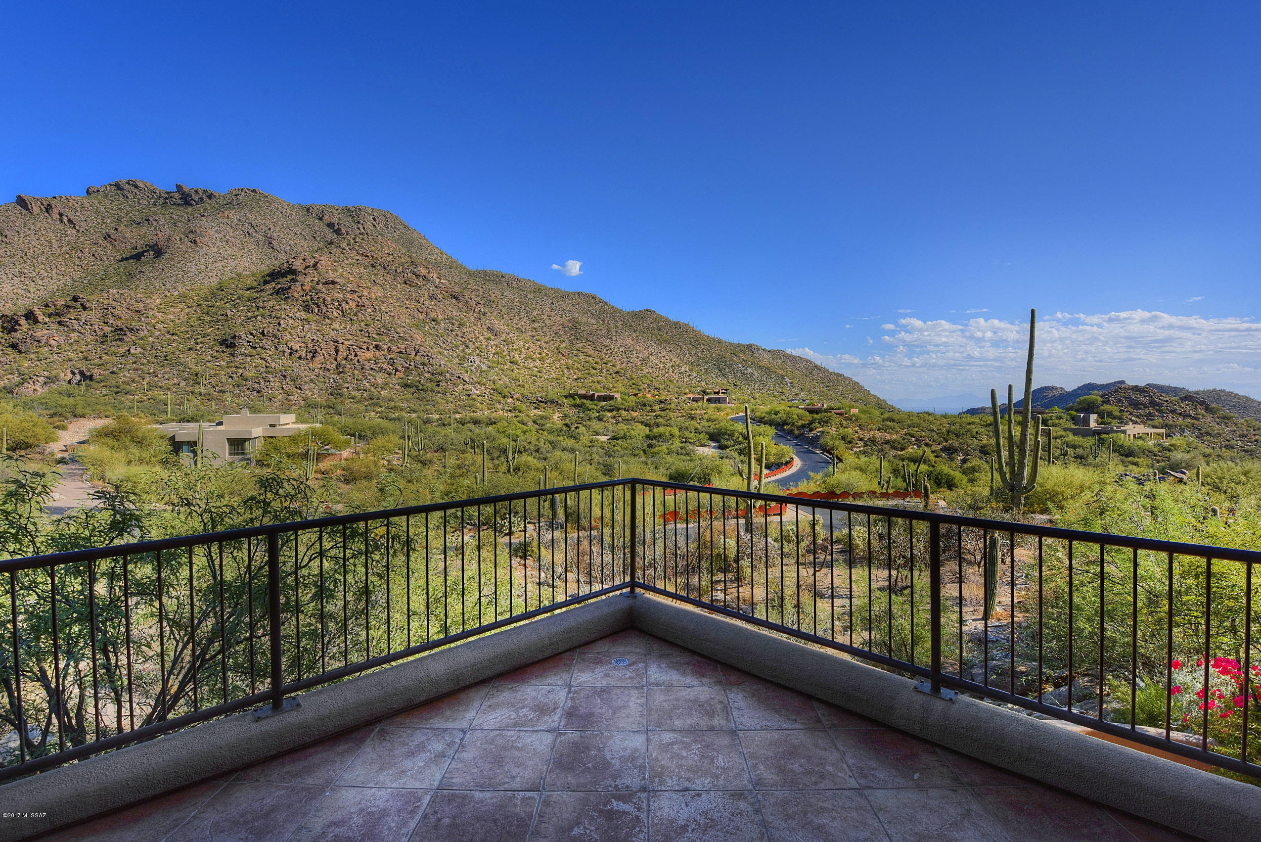 Mesmerizing expansive views from this custom Kevin Howard designed home in guard gated Canyon Pass. Ideally situated against a hillside, home boasts Tucson & Marana city lights, saguaro studded Tortolita Mountain views + sunsets. Stunning location. Unique custom design is great for entertaining and/or enjoy as a peaceful retreat for yourself. Multiple areas that may have multiple uses.Outstanding office location - uniquely situated w/mystifying views. Entire home has endless stunning window views. Some of the many highlights: sun sensor controlled automatic rolling shades, smart lighting & security systems, custom lighted art niches, automatic closet door lights, all wood interior doors, mesquite wood bar & cabinets in family room, private lower guest suite w/kitchenette & private bath.