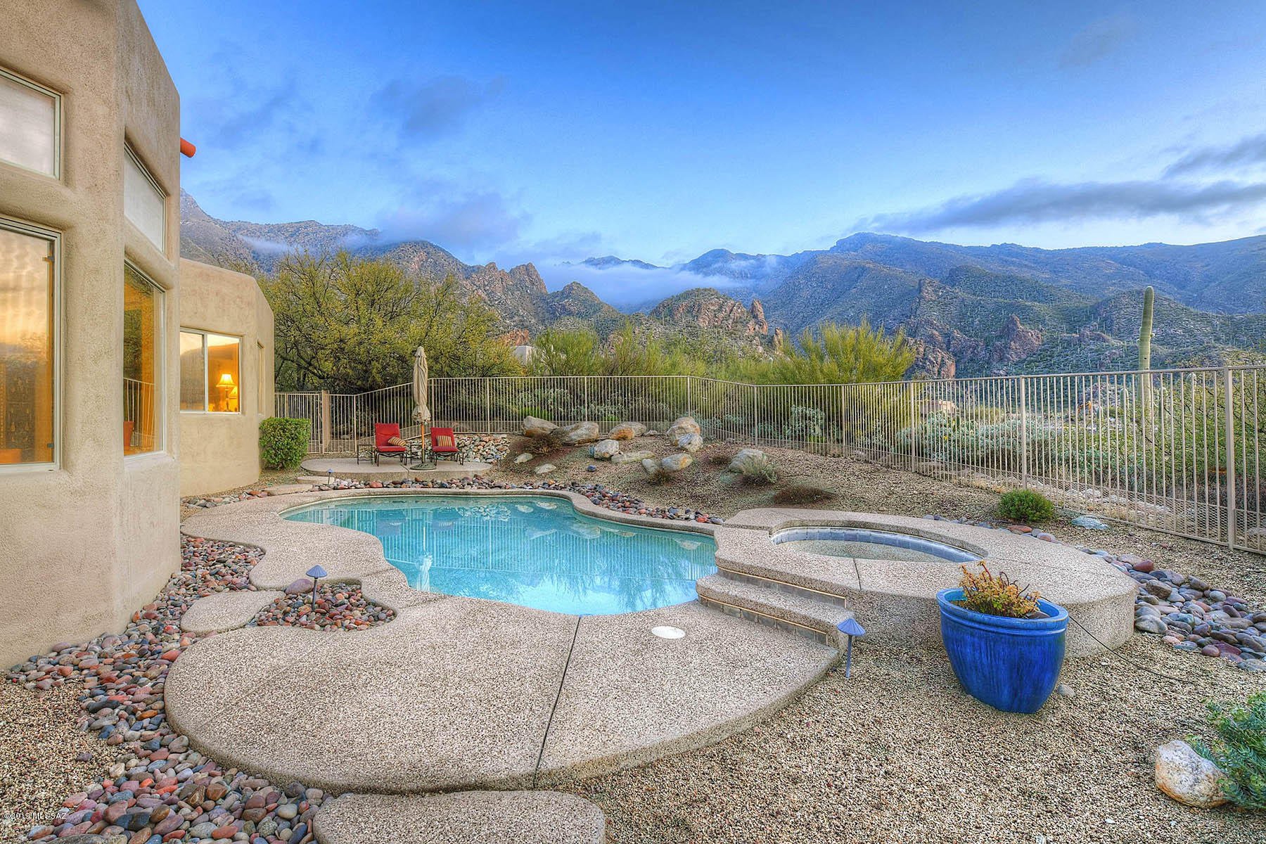 Exceptional private lot located on one of the most northern lots in Alta Vista with splendid Catalina and Rincon mountain, and valley and city views.  Built in 1994 this stunning 4 bedroom 3 bath 2859sf contemporary has mountain views from most areas of home, picture perfect magical backyard with pool/spa and barbeque, a sunset viewing courtyard, split bedroom plan, marvelous updated kitchen with beautiful granite and high end Bosch / Thermador / KitchenAid stainless appliances and Subzero fridge, plantation shutters, his and hers master closets and a  laundry room with built-in cabinets and sink.
Hiking at Ventana and Sabino Canyon is close by.