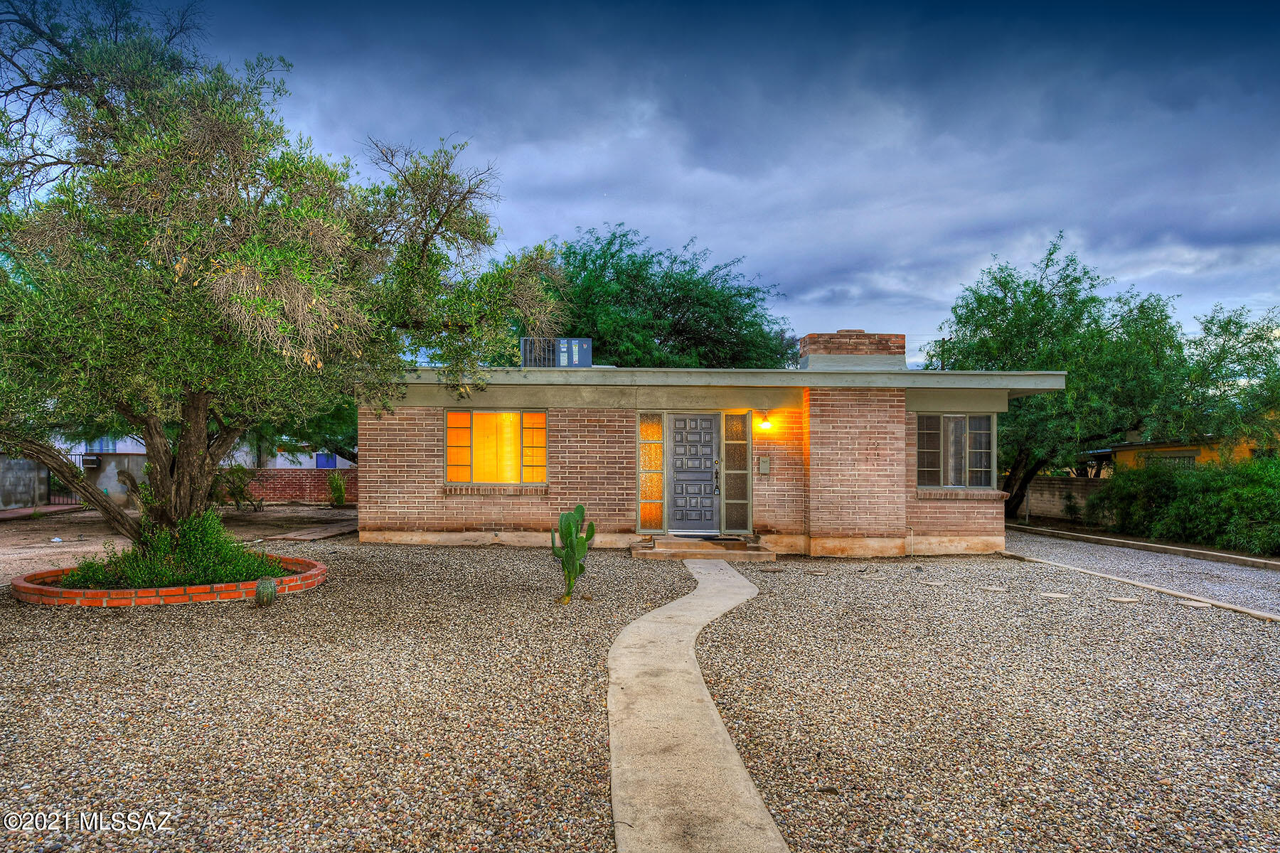 Beautiful Sam Hughes late 1940's moderne.   This home has been in the same family for 73 years and handed down generationally. Timeless features;  Stone faced exterior, Casement corner windows, original colored concrete floors.  Simple but elegant floor plan offers a living room with a brick faced fireplace, dining area, galley kitchen, 3 bedrooms, 1 with French door to the backyard.  Vintage tile in the bathroom.  Large back yard is canopied by mature Mesquite. Tons of off Street parking.  Just steps from Himmel Park & Library, UArizona, Dining & more! On the National Historic Register for Owner Occupants.