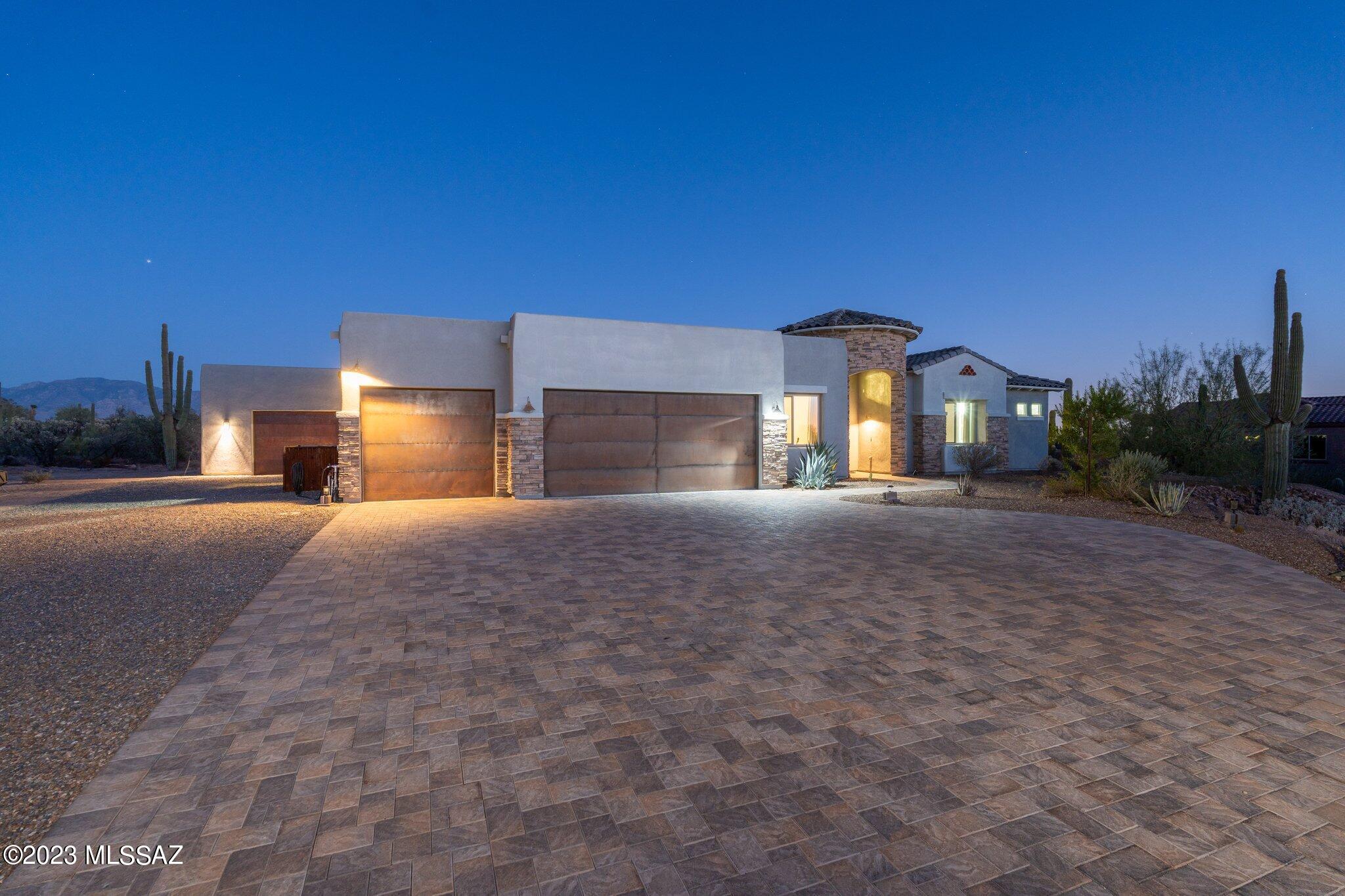 Stunning southwest contemporary home  situated on 3+ac in Rancho Viejo, one of only 5 homes in this charming northwest neighborhood.  Upon entering, you can feel the openness of the space and get your first glimpse of the dramatic mountain views that permeate this lovely home.  The open floorplan features 12 Ft ceilings and a great room that melds seamlessly into the gourmet kitchen w/ upgraded cabinets, quartz countertops, subway tile, and appliances that will please even the most discerning chef.  Take in the views from the spacious dining area, or entertain on the huge covered patio w/pergola and hot tub. Car collectors, craftsmen or artisans will love the workshop complete with HVAC, water and 220V service. Owned solar.  No HOA 
See documents for more added features