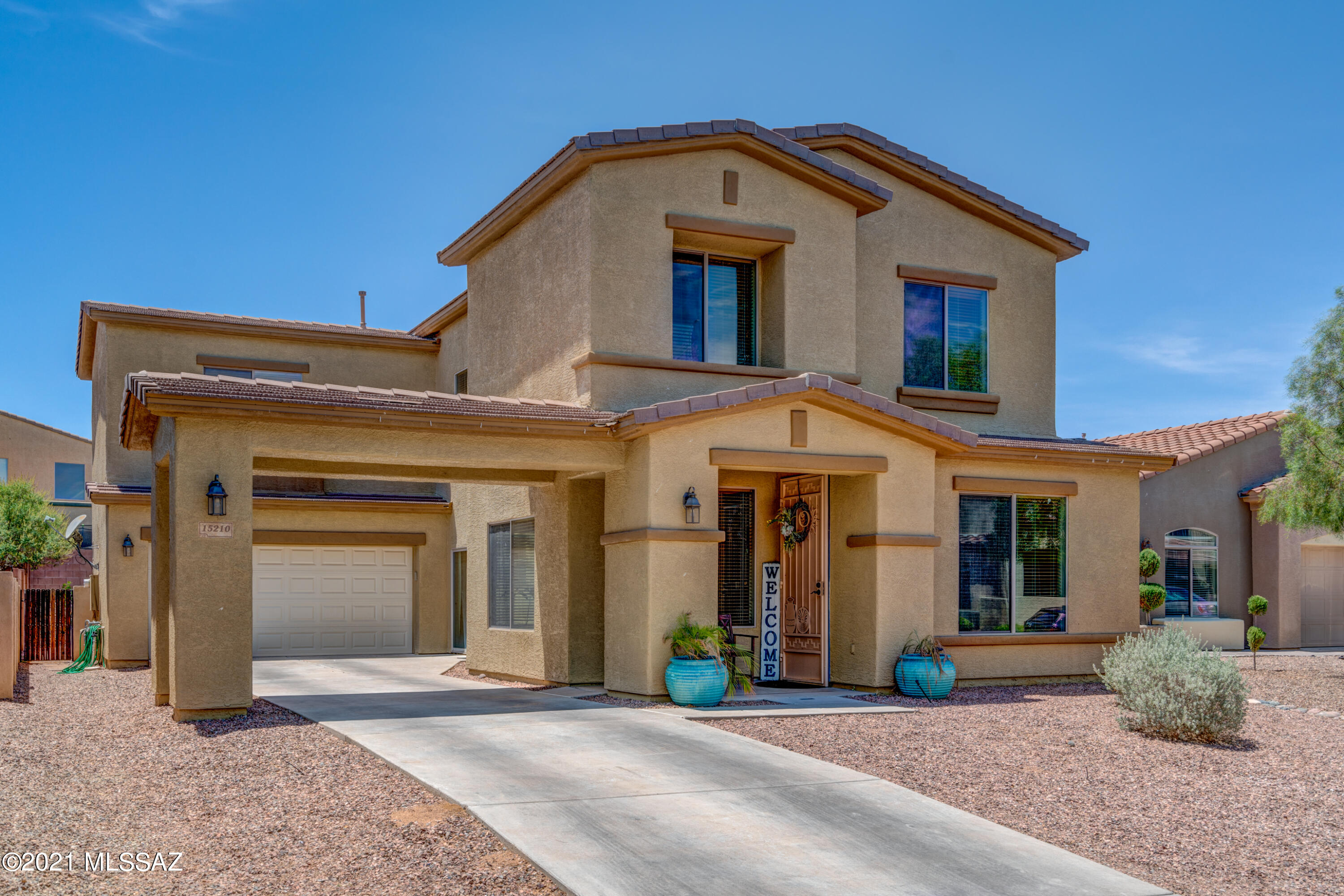 Look no further than this BREATHTAKING Monterey Home located in the HEART of Rancho Sahuarita nestled in a gated lakeside community. You'll be drawn in immediately from the moment you drive up the expansive driveway through the Porte Cochere, providing additional covered parking. Premium interior and exterior paint. Granite counter tops, glass tile backsplash, along with high-end stainless steel appliances are just a few of the details that will make you fall in love with your new home. No carpet here! Dark wood floors throughout. Light wood in all the bedrooms. Upgraded lighting throughout & surround sound wiring. This home features 4 bedrooms (all upstairs) & 2.5 upgraded baths. 2 living areas and 2 dining areas and a large backyard make this an entertainers dream. Lake across the street