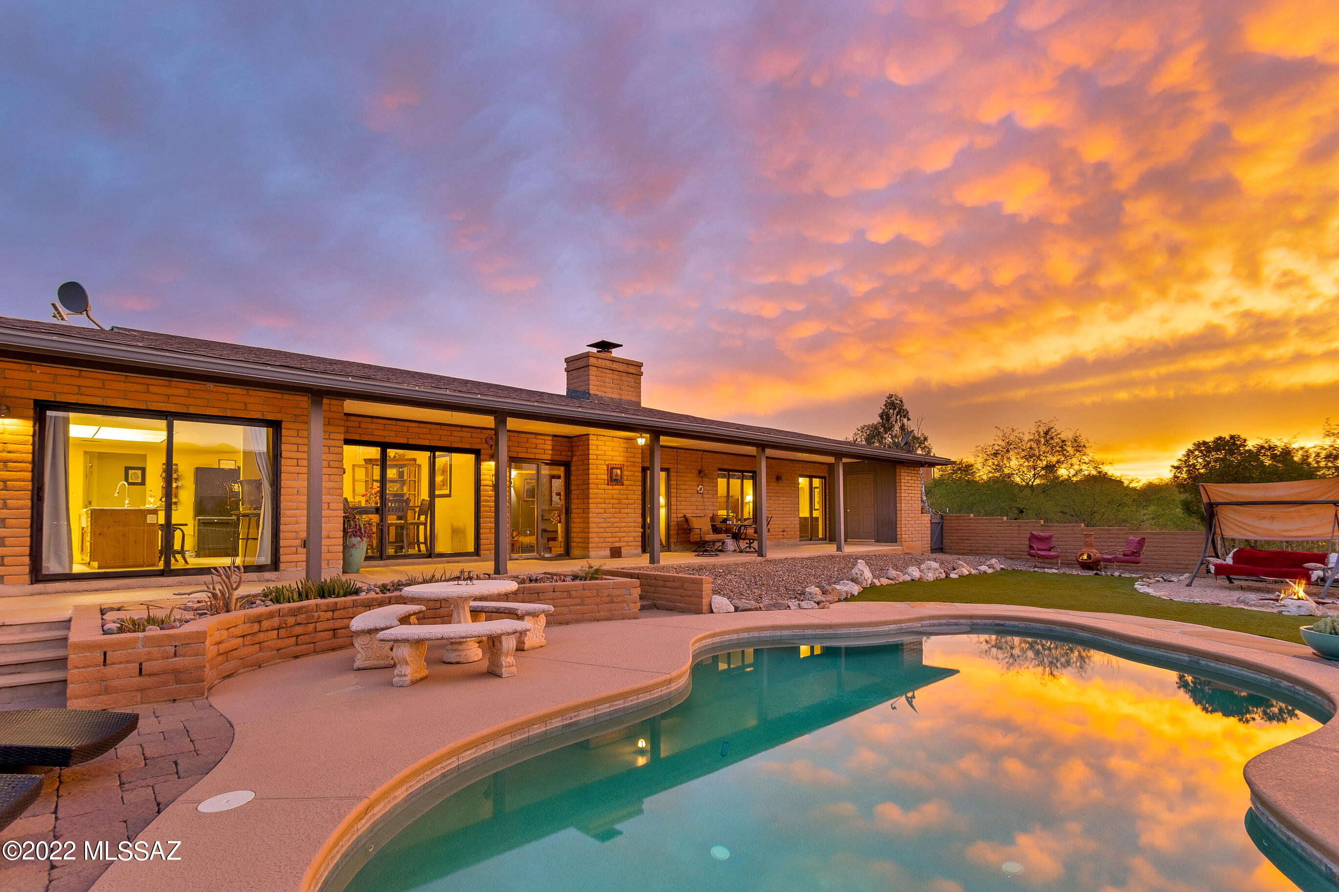 Range Pricing. Seller will accept or counter offers b/w $399,000 & $425,000. If you want Stunning Views of the entire Rincon Mountain Range & Saguaro National Park right outside your Front & Back Yard, then this is your New Home! The Updated Kitchen has New Cabinets, Granite Counters & an Island/Breakfast Bar. The cozy Wood Burning Fireplace compliments the Views & Ambience of the Great Room. Ceramic Tile throughout the home, as well as Spacious Bedrooms & a peaceful Primary En Suite ensure easy living! Hobbyists will LOVE the attached Workshop & Extra Storage (Tuff Shed) & the 1.5 acre lot has plenty of room to store all your Recreational Vehicles & Toys! The Privacy, Views & Lush Desert Landscape plus minutes from hiking make this home ''the one'' you have been dreaming of! Visit today!
