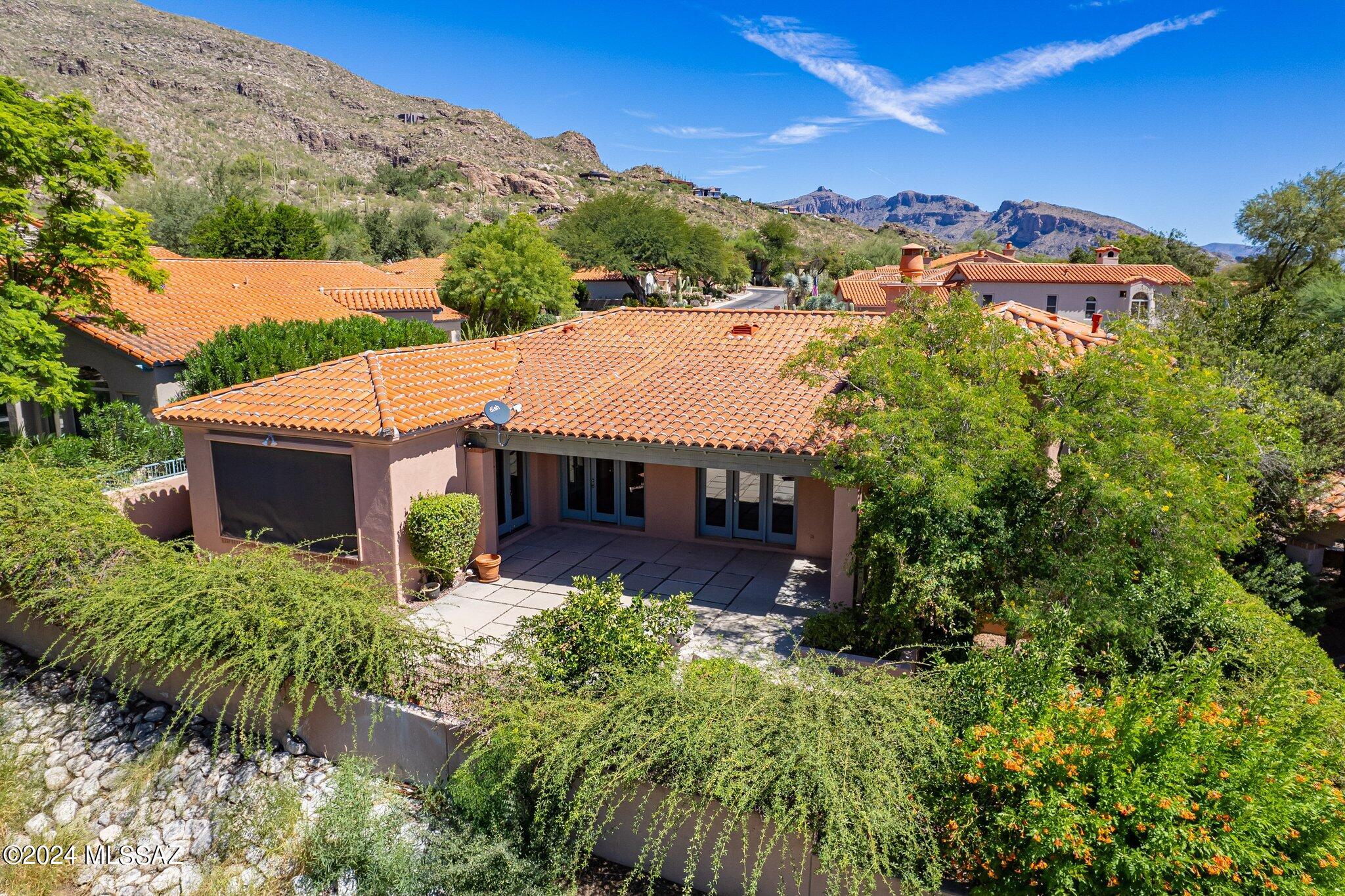 Priced Reduced $200K. Motivated Seller. Exceptional Value. Updated 3 BR & 3 BA w/ Office Home in Gated Ventana Canyon.  This Quality, David Baird Built Masonry Constructed Home Features a Charming Courtyard Entry - Living & Dining Room w/ Vaulted Ceilings, Wood Floors, and Gas Fireplace - Spacious Island Kitchen w/ Granite Counters & Stainless Appliances All Opening to Breakfast Area & Family Room - Upper Level Primary Suite Features Vaulted Ceilings, Balcony, Oversized Closet w/ Washer & Dryer, & Spa Like Bathroom w/ Separate Soaking Tub & Shower - Lower Level Features 2 Guest Rooms w/Jack & Jill Bath. The Private Outdoor Living Area Features a Covered Patio, Built in BBQ, & Lush Landscaping.  Close to Golf,Tennis,Swimming,Dining & More at the VC Country Club. New Roof in July 2024.