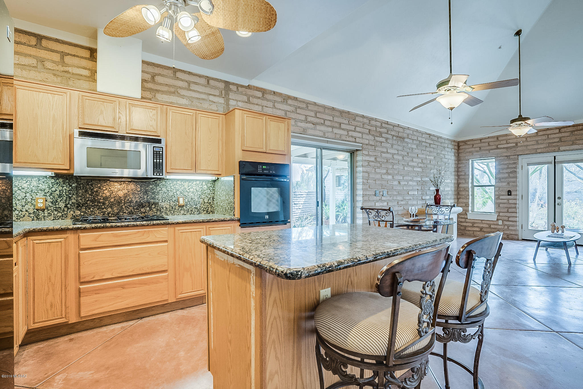This award winning Co-Housing community is built on a 43 acre site 35 of which are reserved as a nature preserve. Milagro is a community with sustainability top of mind. All 28 homes are ''green built'' using high end materials, such as locally sourced hand fired adobe, to keep energy costs low. This home has desert, city, and mountain views. With an open floor plan, private balcony off of the master, a spacious garden courtyard, and wrap around porch there are plenty of places to enjoy the natural beauty. A car port attached to the home provides ease of access. Newly polished and sealed scored concrete floors. Large 'common' house with chefs kitchen, library, kids room and pool. 15 minutes drive to the UofA and downtown this unique property allows you to enjoy both nature and the city