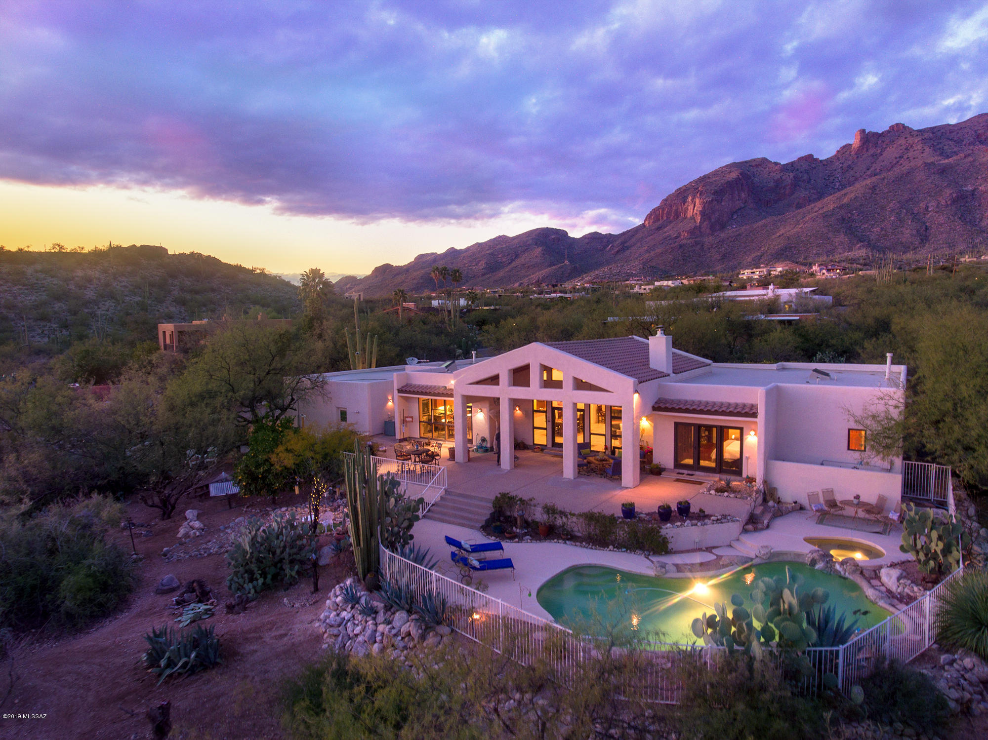 This contemporary marvel will excite your soul and calm your spirit. Designed for positive flow of energy, this home features tall ceilings, wooden rustic beams, an inviting outdoor landscape and the view of Tucson's skyline. Sunrise, city lights, warm sunsets, and purple mountains are now your new arena. Change your point of view!

Entertain with great privacy all year round. Each Bedroom and Den has an outdoor patio with views to the Catalina mountains or to the city.  Enjoy the sparkling city lights from your new master bed. 
Features 5 car garage/ NO indoor steps/ Open + split floor plan/ zen-like patios/ highly desirable DISTRICT #16 school district / 7 minute drive to excellent restaurants and La Encantada mall, AJ's,  walking distance to stunning hiking trails and fascinating nat