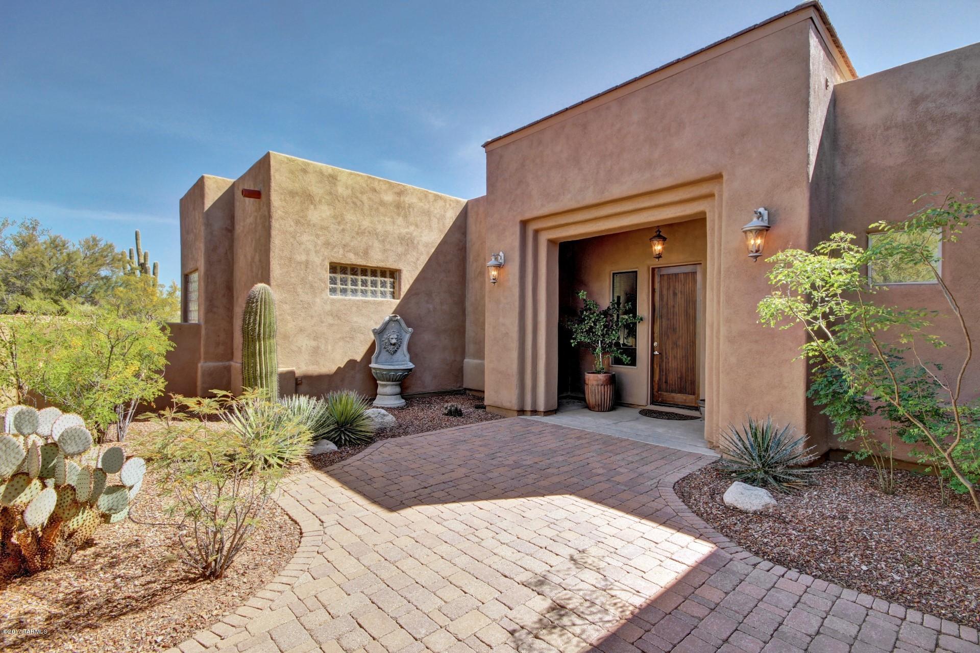 One of a kind custom home on over 4 acres. Premium lot w/ stunning views of
the City and Catalina Mountains. Main house boasts nearly 4000 sq ft of travertine stone flooring, soaring 14' ceilings, chef's kitchen w/ 6 burner Thermador gas stove-top and double ovens. A home owners dream-3 master suites, formal living & dining room, executive size office, family room w/ log burning gas fireplace, recreational room and 3 bay garage. Owner's
suite features his & her closets, fireplace, 14' coffered ceiling, his & her vanities & a jetted tub. The expansive windows in each living space allow you to take full advantage of the beautiful setting. Pebble-tec pool and spa. Unbelievable detached guest house offers 1171 sq ft of luxury living. Guest house includes 2 bed/2 bath, kitchen & 2 car garage Guest House is ADA compliant. One of the owners is licensed to sell real estate in Arizona