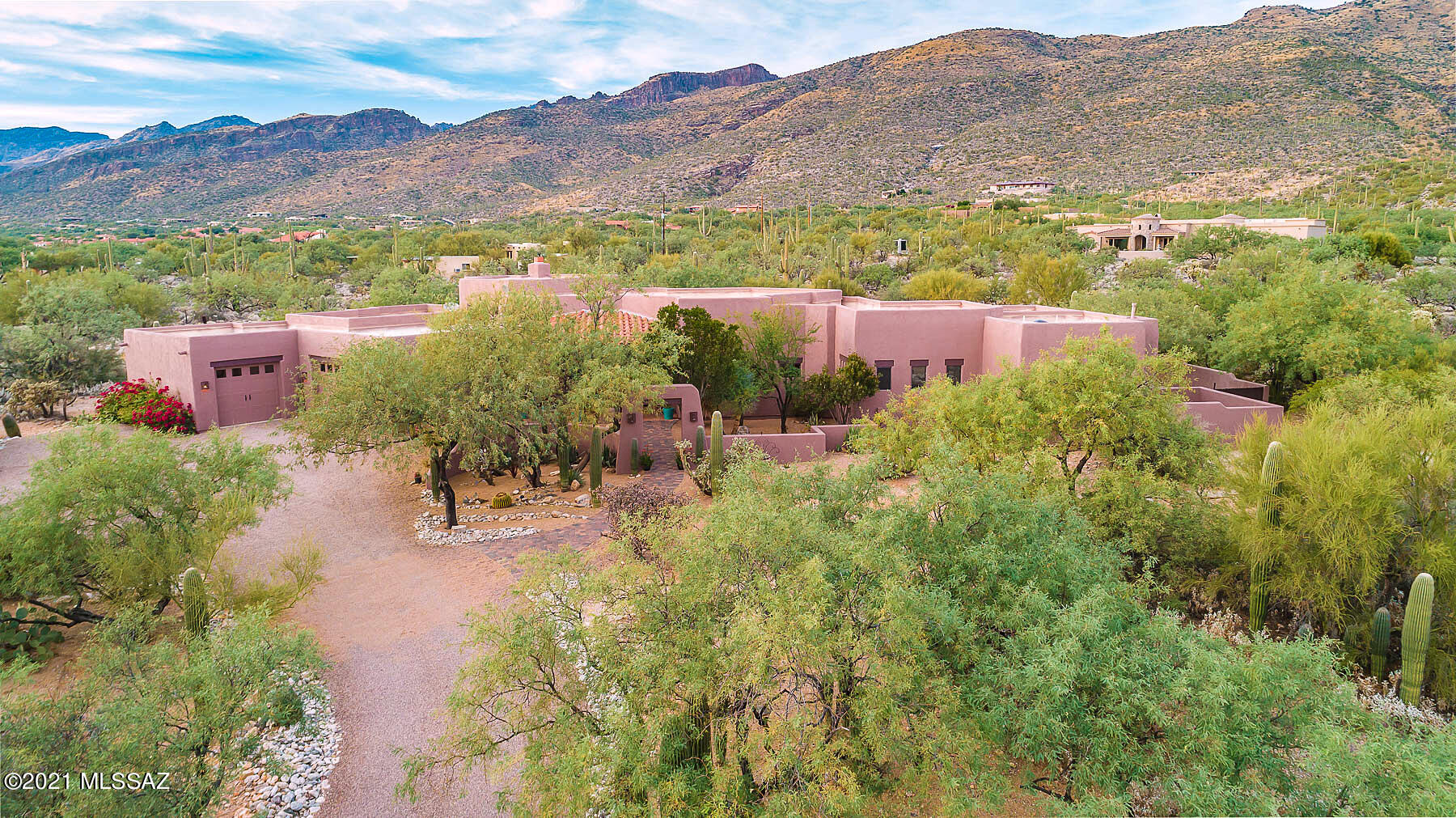 A rare opportunity to own a beautiful Santa Fe style home in the sought-after gated community of Saguaro Hills Estates (Fetzer Ranch) at the base of the Catalina Mountains. Nestled peacefully on 3.32 acres, this split-plan 3022 sq has 3 bedrooms, 2 ½ baths, office, gourmet kitchen equipped with granite countertops, separate prep counter & sink, stainless appliances, double ovens, large walk-in pantry, separate wet bar, water softener & under sink R/O system. Upon entry, the North-facing wall of windows give stunning views of the Saguaro-lined Catalina Mountains and fills the home with an abundance of natural light enhanced by 13 ft sawn beam & saguaro-ribbed ceilings. Front courtyard and covered patio give views of Rincon Mountain & the Tanque Verde valley. Gas Kiva-style fireplace, saltillo tile throughout main living area, new carpet in master and guest room, newly painted interior. 3-Car garage & , extra storage room both with built-in cabinets. New 2-stage HVAC/furnace. The plastered pool and spa (recently R/O'd) has a new Energy Star pump, new glass-bead filter and new pool cleaning pop-ups. The over-sized, fenced-in backyard features multiple seating areas including main covered patio & covered master-bedroom patio to enjoy the city, mountain and sunset views, plus a circular gas firepit to enjoy the cool fall evenings. A must see