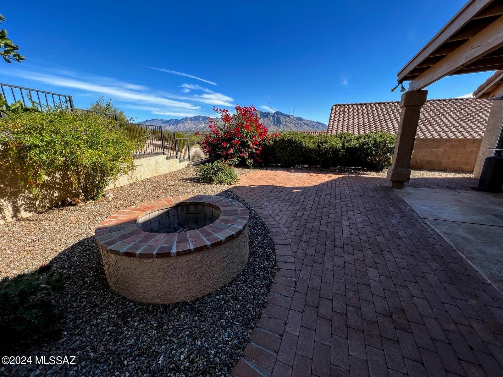 TUCSON NATIONAL HOME, Gated Community, Unfurnished, Elevated Lot backing Golf Tee with Beautiful Mountain Views! Two Bedroom PLUS DEN, Two Bath. Enjoy the Hot Tub, Fire Pit, Private rear yard with Views! Upgraded Kitchen with Gas Oven/Range, STAINLESS appliances, GRANITE Counter Tops, Rich Cherry Cabinets, Large Living room and Family Room separated with 2-Way Fireplace! GATED Community. NO CARPETING: Saltillo Tile and Wood Flooring throughout. Pets with owners' permission. Contact Listing Broker for your personal showing today! FLEXIBLE LEASES! Contact Listing Broker today!