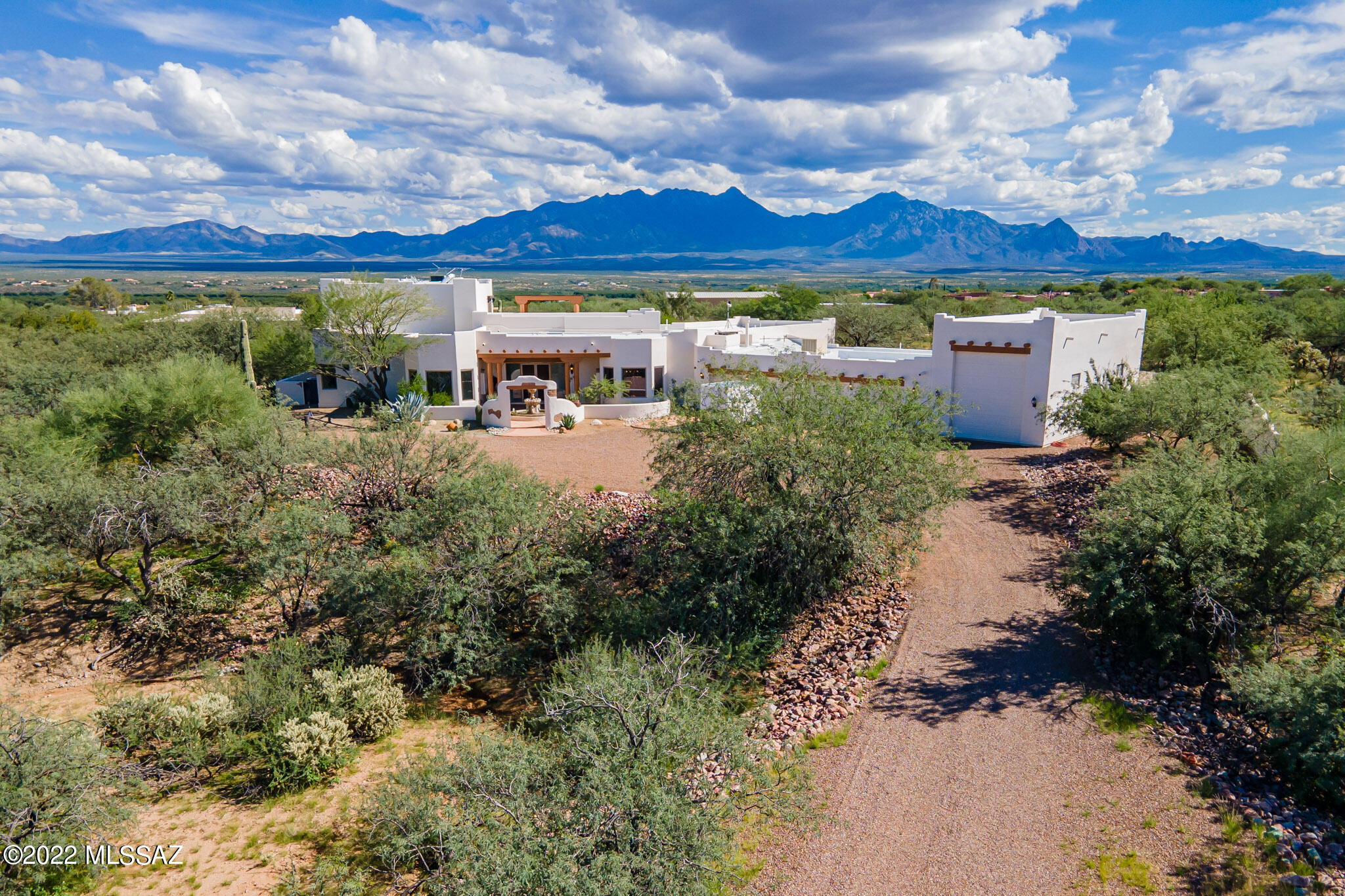 Luxurious Santa Fe home in the prestigious Foothills of Green Valley. Complete Comfort with every amenity, inside and out, wrapped in a Spectacular Setting on 3.3 acres of privacy, desert wildlife and Awesome Views. 15ft wood/beamed ceiling in the great room. Huge Gourmet Kitchen featuring Hickory cabinets, Sub Zero refrig and freezer, Dacor 6-burner gas cooktop in the 7ft granite island, prep sink, butler pantry, wet bar. Enormous Master Bedroom Suite with a 10x10 custom walk-in closet adjacent to the laundry room and elegant bath. Separate wing for the two guest ensuites. All rooms including a full bath open on an Amazing Resort-Style Patio, Saltwater Heated Pool, Spa, Outdoor Kitchen, Firepit. A spiral staircase leads to the 2nd floor Viewing Deck and interior theater/media room. The upstairs with its bathroom could be converted to another guest suite, office or hobby room. An abundance of built-in cabinets in the 4-car garage and a separate room assure plenty of storage space. A circular driveway allows easy maneuverability into the 45ft RV garage with 200amp service. Zoned heating/cooling in the home and a portion of the 4-car garage. This special property showcases extensive detailing and superior quality throughout. Schedule a showing today to tour one of Green Valley's finest.