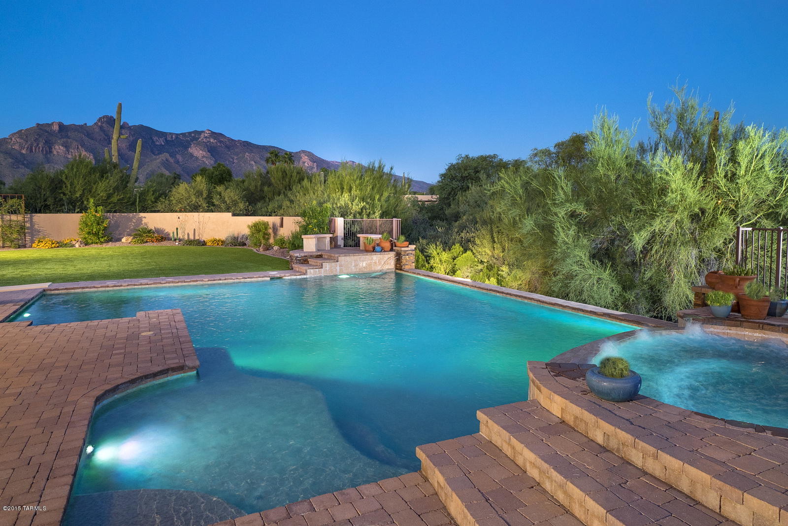 This one of a kind beauty has all of the features sought but never found at once in Dist. 16! Nearly 4000 sf. of luxury finishes: travertine, knotty alder wood, soaring ceilings, four carpeted bedrooms each with their own walk in closet and bathrooms with designer tile work, a master suite to die for with a jetted tub, steam room, walk in closet, double sided fire place, and a private entrance to a second patio. Surround sound, smart wiring, intercom, HVAC, central vac, an office and a heated/cooled separate fourth bay in the 4 car garage are among other conveniences. Chef’s kitchen features two SS dishwashers, double ovens, advantium oven, lg walk in pantry, & an enormous center island with prep sink. Seller is offering $10,000 towards buyer’s closing costs.  (Click More) The resort backyard boasts a giant high tech salt water, pebble sheen pool and spa, XL grill, built in granite bar and gas fireplace, expansive, no maintenance artificial grass, and new inground trampoline. Enjoy views of Finger Rock Mtn. from the yard or take the spiral staircase to the upper deck where city lights twinkle.The house is well located on almost an acre of privacy, with a wash on two sides. All this in a highly desired neighborhood with top rated schools and close to everything!  Simply spectacular! Remember, the seller is offering $10,000 towards buyer's closing costs.