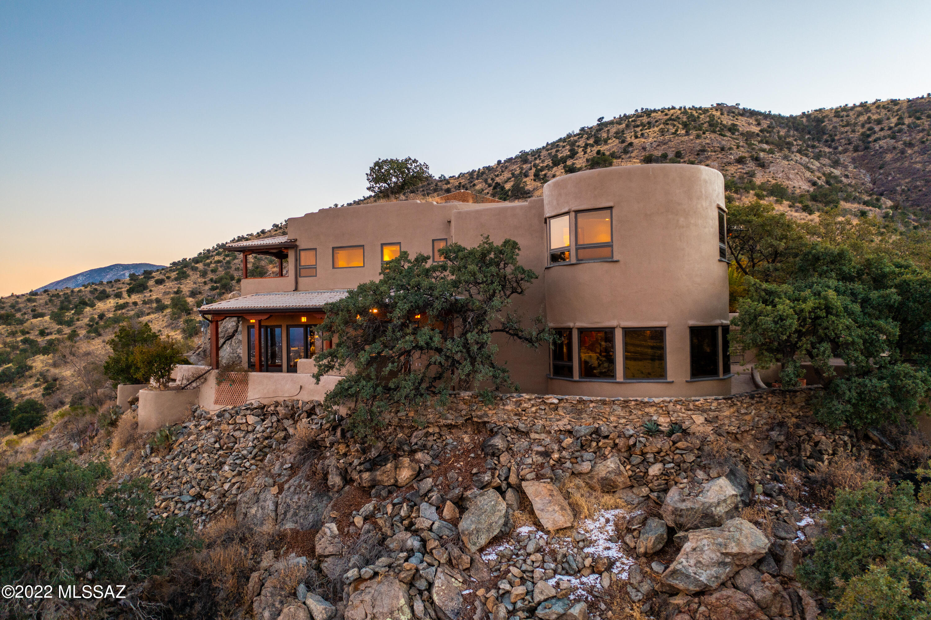 Nestled at the base of the Huachuca Mountains sits an exclusive property that boasts almost 2.5 private acres and over 2,900 sqft of living space built directly into the ridgeline natural rock formations. Above the detached oversized 2-car garage is 749 sqft of semi-finished space, best suited for an art studio, workout area, or can be converted into a 1 bed/1 bath guest casita. Enjoy cooking in your chef's kitchen, featuring a 6-burner cooktop w/ pot filler, double ovens, 2 prep sinks, warming drawer, and dual cooling drawers. The butler's pantry includes additional storage and prep areas, built-in wine cooler, and 2 additional cooling drawers. Dine in luxury surrounded by sweeping, panoramic views. Searching for that truly one-of-a-kind home...you have absolutely found it here.