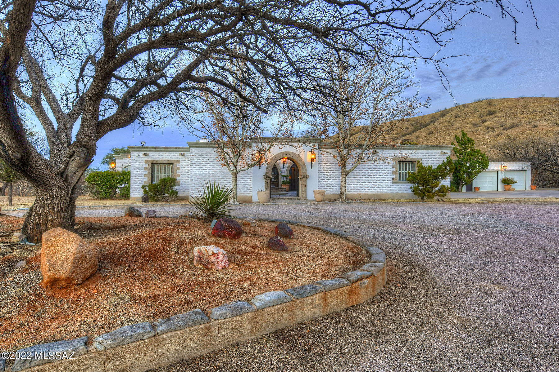 MAJOR PRICE REDUCTION! 
WELCOME TO THE C7 RANCH, A CUSTOM ADOBE RANCH ESTATE. Built in 1972, this custom-built adobe brick house sits on 106 acres of rolling ranch land, with fencing, corral, water and more.  Spanish style home features handcrafted Mexican stone, marble and tiles. Grazing lease is currently in place to keep taxes low.  Five bedrooms, five baths of classic southwestern ambiance. Although this home's original beauty and features remain intact, it has been lovingly maintained over the years, including the roof re-coated, fireplaces cleaned & new sewer line to septic in 2021.  Bring your vision and ideas for updating this home while maintaining its character.  Needs some updating & fixing up. Truly a rare find -- an elegant ranch, private yet close to city services.