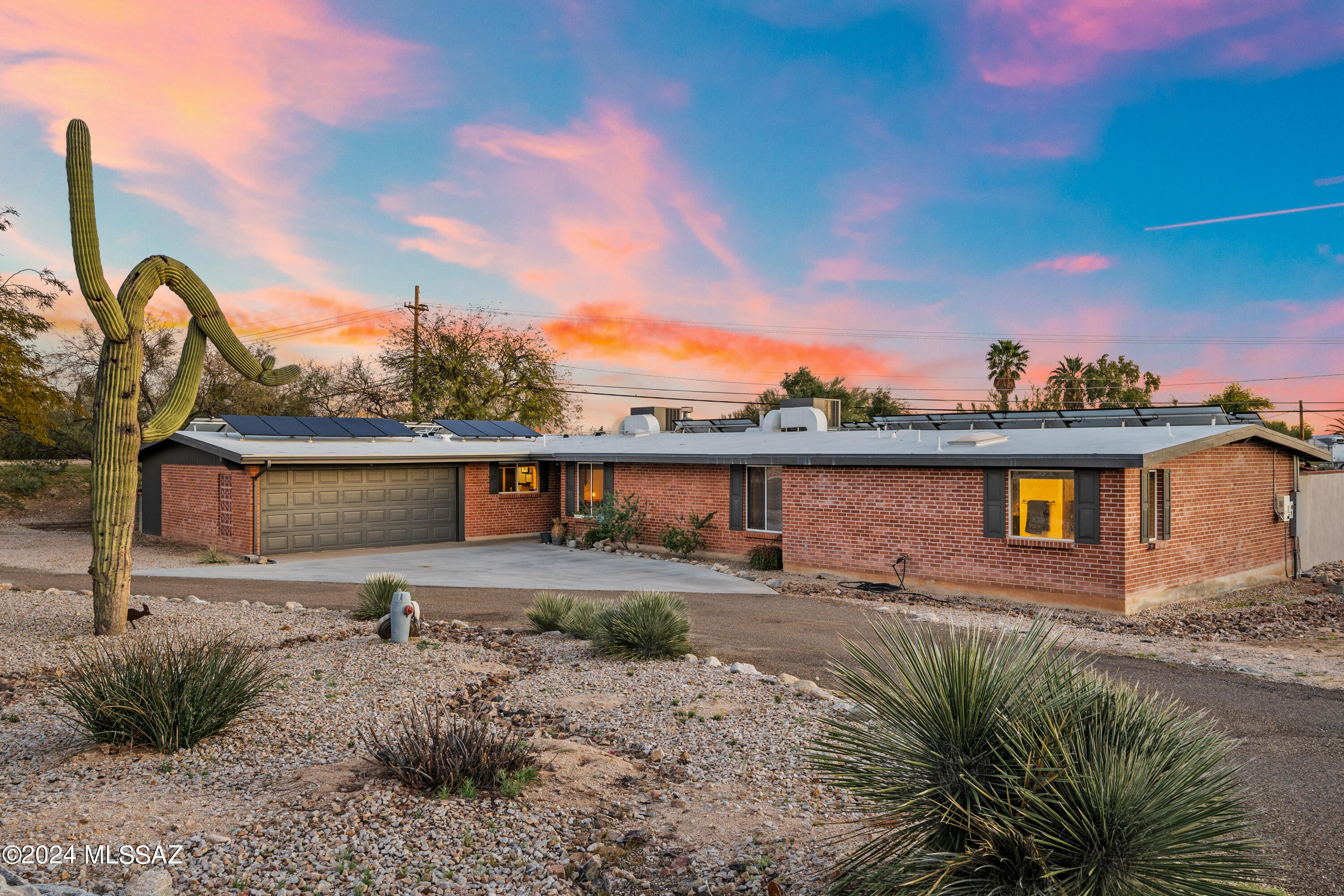 Spectacular upgraded 5BD/3BA (2,775 sq ft) home on over 3/4 acre in Northwest Tucson w/ mountain views, new sparkling pool, play area & NO HOA!  Arrive through circular drive & stroll through the attractive foyer into the large gathering room w/ knotty pine ceilings, gas FP, & spacious dining area w/ coffee bar. Kitchen has all newer SS appliances, gas cooktop, island with breakfast bar & nook. Oversized primary bedroom w/ gorgeous ensuite bath, walk-in closet, & direct access to back patio. 2nd bedroom w/ ensuite bath also has walk-in closet & direct access to patio. Backyard is an entertainers dream w/ 2 large outdoor entertainment areas, new built-in BBQ & area for dogs. Relax under the pergola or soak in the new pebble sheen pool w/ Lagoon. Too many upgrades to mention! A Must see.
