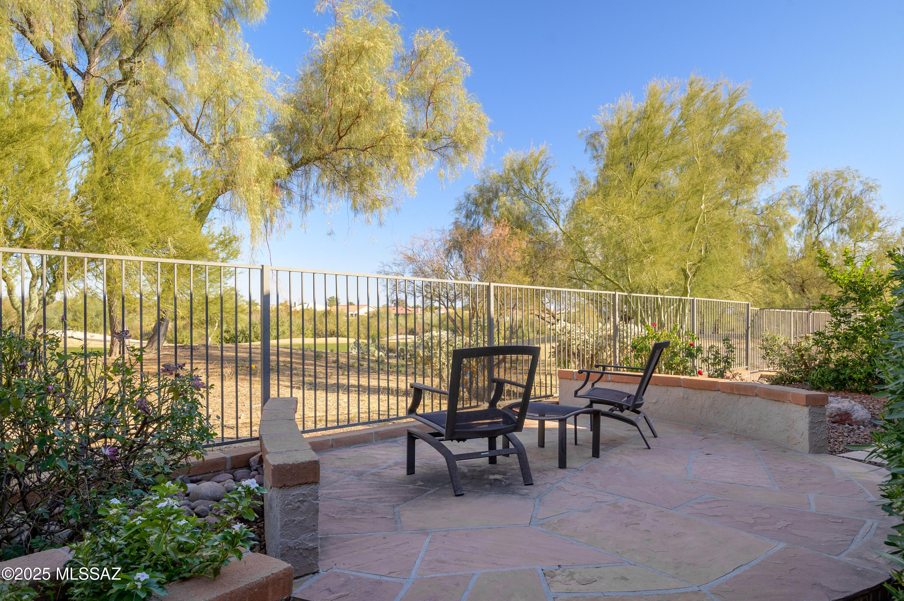 Sitting high on an elevated golf course lot, this is a property you'll want to call your own! You will love this 2 bed/2 bath expanded Crestview Model, located in coveted Sun City Oro Valley. The flagstone walkway leading to the double-doored entryway welcomes you home. The light & bright kitchen has an island with electric cooktop, updated cabinets, Corian countertops, two wall ovens plus views of the Catalina Mountain range. A large nook and family room with cozy gas fireplace is located just off the kitchen. An impressive bonus to this home is the spacious room addition accessed just off the kitchen nook. This extra room, showcasing more mountain views, features space for a pool table, built-in cabinets/shelving and plenty of room for all of your hobbies.  The large formal living room with dining area allows expansive views of the beautiful patio and open spaces, plus the 9th Fairway of The Views Golf Course. Plantation Shutters add an elegant touch. The guest bedroom, located with easy access to the guest bath, features 2 closets for extra storage. Upon entering the spacious Primary bedroom, you'll be welcomed by beautiful views of the lovely backyard, green space and more golf course views. The en-suite bath features dual vanity, tub, shower and walk-in closet. The backyard of this spectacular home is the showstopper! Stunning views, privacy, extended patio seating areas, sun shade, easy-care yard and fruit trees all invite you to spend more time outside. Top this off with the peaceful rock waterfall and you have the perfect relaxing and entertaining space. Don't miss this one-of-a-kind golf, Catalina and Tortolita Mountain view home. Begin your active adult lifestyle today!