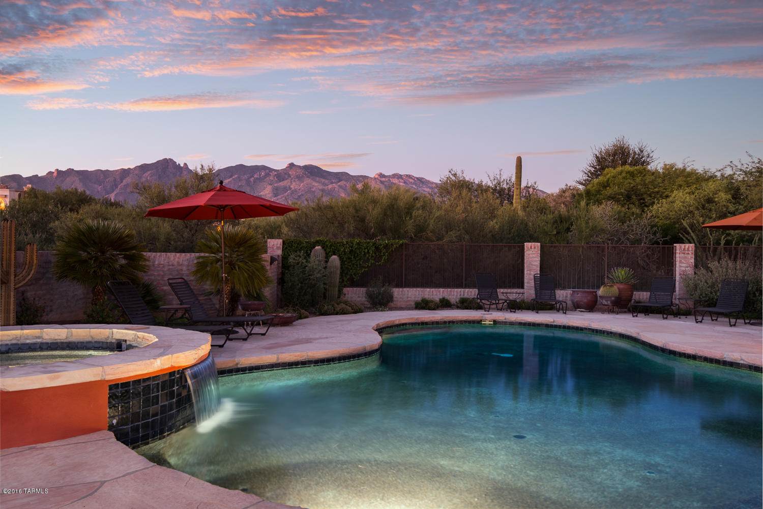 This charming Territorial on a very private 1.8 acre lot is a hidden treasure!  Enter thru beautiful cactus sculpted iron gates into a large inviting courtyard with a Lee Blackwell fountain and lush landscape. The Great Rm /
Formal Dining is spacious with huge wall to wall windows to enjoy sweeping views of the Mtns, Beamed ceilings, gas FP and Plantation Shutters.  The Family Rm is open to the Kitchen with Granite counters, center Island & newer appliances. Split Bdrm plan so that all 3 bdrms are private and separate.  Luxurious Mstr Suite is spacious and has outstanding Mtn views.Resort like bkyd with covered patio area, Built in BBQ & multiple Flagstone Decks, Bancos & FP.  Pioneer Pebbletec pool & Spa, wonderful Mtn Views. Truly spectacular spacious area for  entertaining and outdoor living. Very Private!