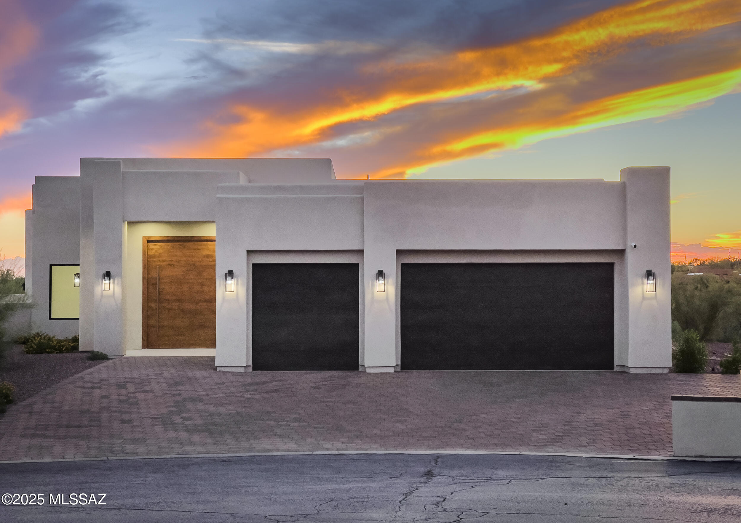 Absolutely stunning 360 degree panoramic mountain & city views will capture your breath as you enter into this newly constructed & exceptionally upgraded contemporary home on a huge 3.52 acre lot. This 4 BD/4BA/3,320 Sq.Ft/3 car garage home has an inviting & open concept floorplan. Enter through the large rotating solid wood door & into the spacious family room. Separate living area w/wet-bar & wine fridge. Chef's kitchen offers beautiful quartz counters w/waterfall design on the kitchen island, custom cabinets & pulls, upgraded stainless steel appliances, custom light fixtures, breakfast bar & walk-in pantry w/built-ins. Master suite is spacious w/slider to patio, dual vanities, soaking tub, tiled walk-in shower & large walk-in closet w/built-ins. 2 Guest bedrooms are en-suite **(MORE)** ....w/walk-in closets. All tile floors throughout, custom & solid wood doors & trim, light fixtures, tray ceilings & more highlight this custom built home. Backyard offers a large covered patio, artificial turf, professionally landscaped & panoramic views. Conveniently located close to schools, shopping, restaurants & more in Oro Valley's desirable community of Chaparral Heights.