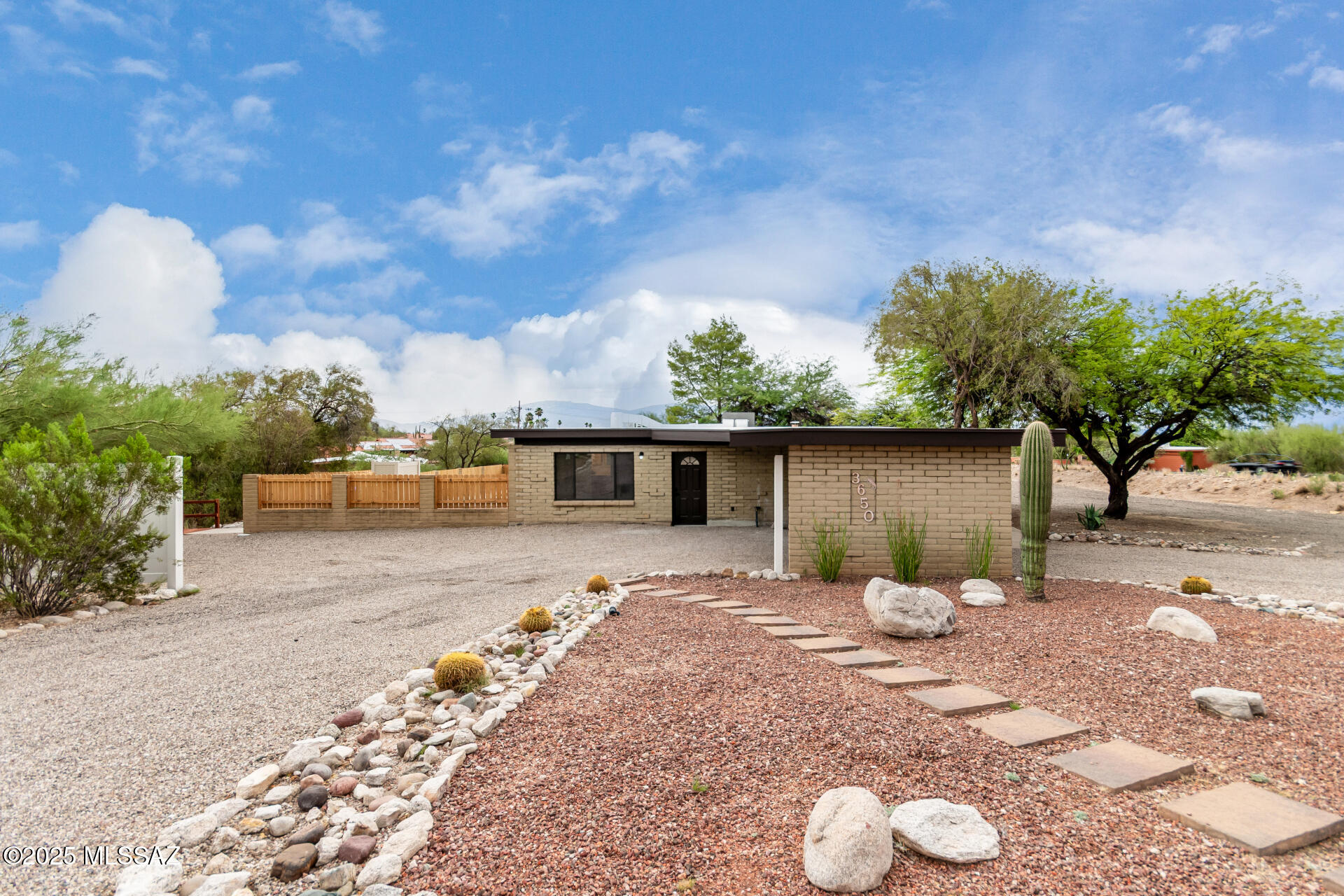 Experience comfort & convenience in this upgraded home in the desirable Tanuri Hills neighborhood! Featuring carport parking, circular driveway, & easy-care desert landscape. Inviting interior boasts a welcoming living room & a bright family room w/an exposed ceiling beams & a cozy fireplace w/backyard access. Renewed eat-in kitchen comes w/recessed lighting, tile backsplash, new SS appliances, quartz counters, & a breakfast bar. This gem has two (2) master suites w/ plush carpet, walk-in closet, bathroom, & backyard access. Primary has a trendy barn door leading to bathroom w/dual sinks. Enjoy amazing mountain views from the serene backyard, complete w/a covered patio, enticing pool, spa, & sport court - ideal for basketball or pickleball! Great for entertaining! A MUST see! Agent/Owner