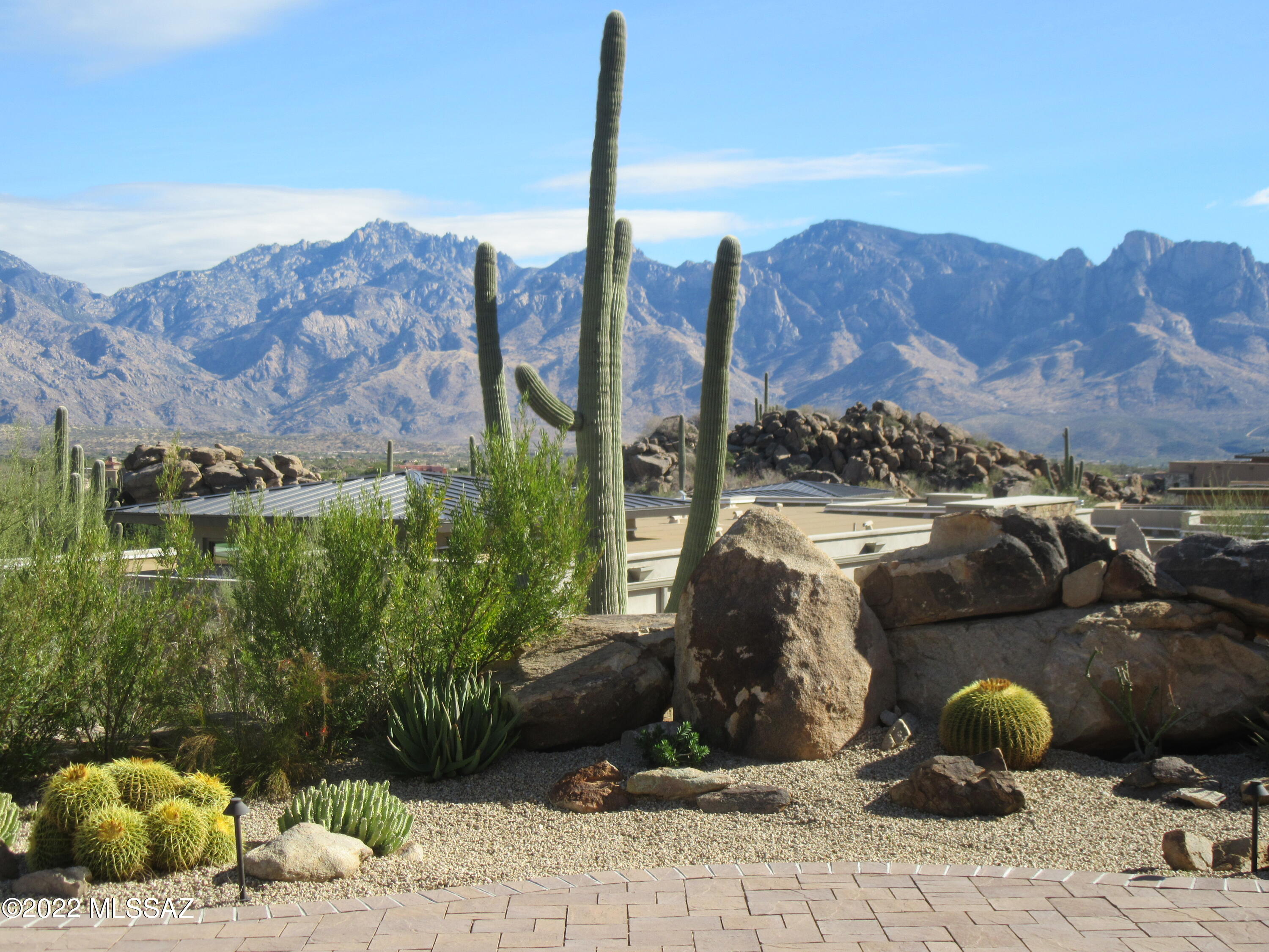 Jaw dropping panoramic Santa Catalina Mountain views from this elevated near 1 acre premium homesite in the gated Boulder Vista section of Stone Canyon. This incredible desert setting is defined by unique rock formations, hundreds of giant saguaros, solitude, and mountain views that will take your breath away located near The Stone Canyon Club. This 2018 energy efficient home built by Meritage will endear you from the moment you enter, delivering extraordinary privacy and remarkable views coupled with thoughtful design and artful execution for the ultimate in desert living. Driveway lined in pavers leads to covered front entry w/stacked stone and metal accents. Creatively designed split bedroom floor plan efficiently utilizes space providing a manageable sized home without sacrifice. The living room has 16 ft. ceilings adorned with clerestory windows which amplify the natural light in the room. The rest of the house has 12 ft. ceilings which gives the impression that each room is bigger than its actual size. Oversized kitchen island w/quartz countertop, high-end KitchenAid appliances, and well outfitted cabinets galore with a separate pantry add to the value this home delivers. Very generously sized master bedroom and an attached bathroom which has a large picture window through which you can see a mini mountain of rocks, which deliver total privacy without any need for shades or curtains allowing daylight to light the room. The laundry room is roomy with an Electrolux washer and dryer, a utility sink and large upper cabinets. Just inside the front door, there is an open cozy office/sitting room perfect for working or reading. All the large glass windows and doors add to the excitement of this home's allure by bringing the natural beauty of this property indoors. Seeing is believing! Come tour this property today and see for yourself!