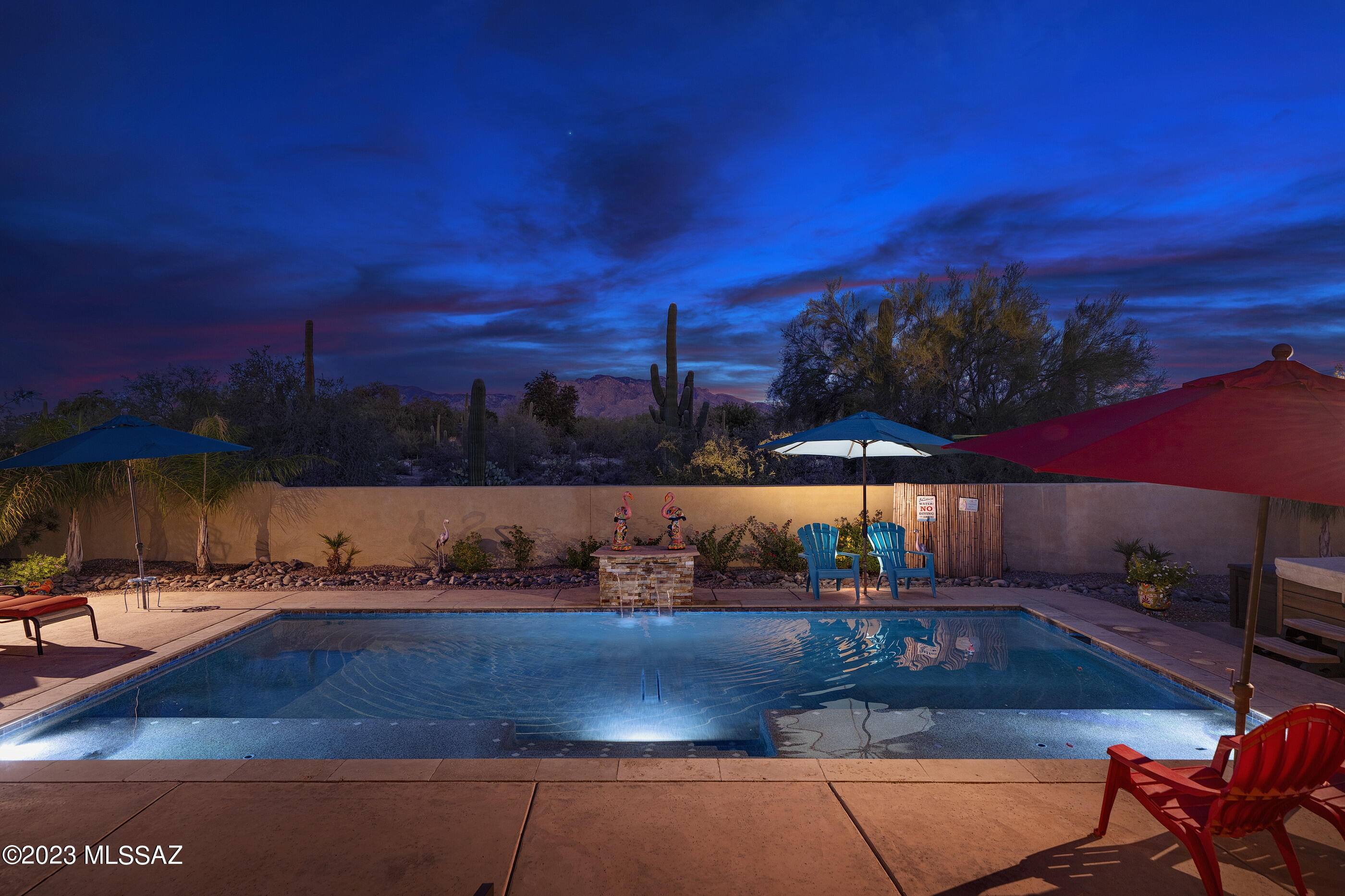 This gorgeous home on 3.34 acres in popular Northwest Tucson hits all the checkboxes—including mountain views inside and out! From the soaring wood ceiling to the tumbled travertine floors, this 3031 square foot home with owned solar is loaded with architectural detail and excellent finishes.  
The excellent split bedroom floorplan with dual primary suites offers lots of flexibility depending on your needs and features a great room concept open to the kitchen. This home is Southwest done right—wood posts, viga beams bring interest to the space without overwhelm. Windows span the main living space, overlooking the pool and showcasing Catalina Mountain views.  A wall of dramatic display niches is accentuated by a custom cut out design as a nod to the mountains.  Tucked to one side of the living space is a delightful conversation area with a kiva style fireplace and a banco hearth. 
The kitchen features maple beadboard cabinetry, granite counters including a breakfast bar and all appliances, complete with a six-burner gas stove. An adjacent bar area with custom mosaic tile and travertine backsplash offers extra counter space and pantry cabinets with pull-outs. 
A flex room with its own access door to the front courtyard is currently used as a formal dining room but could also make an excellent home office. There is a convenient half-bath located nearby. 
Both primary suites offer access to the backyard through French doors, large walk-in closets and beautiful baths with travertine showers. The suite on the south side of the home also offers a large soaking tub. The third bedroom is serviced by a hall bath with another travertine shower and has its own private patio. All bedrooms currently have carpet, but there are polished concrete floors underneath should you desire all hard-surface flooring. 
And the beauty of this home isn't just skin deepthe infrastructure also includes two newer Trane HVAC units, a central vacuum system and the owned solar with transferable net metering boasts a $22 a month bill. Plenty of room for storagethere are extra closets throughout the home and even more storage space in the extended 3 car garage. The laundry room with a door to the outside is a dreama generous sink, cabinets lining both walls and more counterspace than some kitchens! 
Outside, enjoy the views from your 30x15 pool with lagoon seating, fountain and in-floor cleaning system. The is also an above ground spa for soaking on cool desert nights. While the fenced area is landscaped, this fantastic property offers plenty of space outside of the fence to add gardens, sports courts, a swing studio, a workshop or even a guesthouse.
Your new home is very close to the world-famous Tucson Omni National Golf Club & Resort , the Northwest YMCA and the soon to be reimagined Foothills Mall.