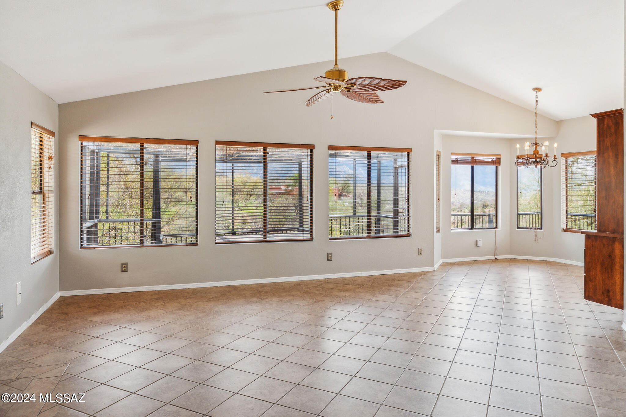 PRICED TO SELL! Amazing Views! Perfect retreat in Catalina AZ, offering stunning mountain views that will take your breath away! This well maintained property offers an inviting ambiance- the great room is accented with a vaulted ceiling and fireplace, a dining area off the kitchen all showing off the magnificent views of the mountains and sky. Remodeled fully accessible cooks' kitchen has custom glide out and pull down shelves, granite countertops w designer glass backsplash, double ovens,GE & LG appliances and a pot filler faucet above the  cooks dream 5 burner stovetop. Primary remodeled bathroom has custom walk in tile shower, elegant curved cabinetry w dual sinks, granite tops and elegant storage options. .  (SEE MORE) Tiled throughout for easy Arizona living. Modern upgrades including new paint inside and out,freshly re-surfaced ceilings w no popcorn! Transformed with thoughtful design, the garage has been converted into a cozy family room with a wood-burning stove, perfect for chilly evenings. Embrace the outdoors on the wrap-around balcony or within the gated courtyard, where panoramic views enhance every moment. Equipped with practical amenities, this home includes a whole-house water softener system, ensuring comfort and convenience. Experience the freedom of easily accessible paved roads, an owned solar system, and no HOA restrictions. This property supports the Self Sufficiency Prepper lifestyle with abundant secure temperature controlled storage options, a water harvesting cistern and privacy. Endless recreational possibilities include hiking, biking, horseback riding, and ATV trails nearby. This residence promises a lifestyle of adventure, relaxation and privacy. Explore the nearby vibrant community of Catalina, where local restaurants and shopping are minutes away. Experience the ultimate in comfort, peace and ever changing mountain views!