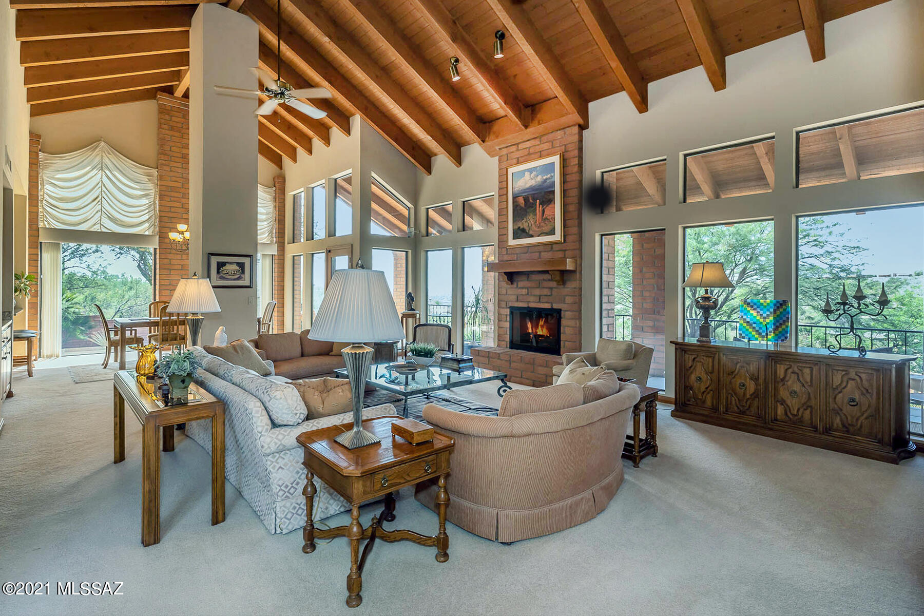 Wonderful home in the Foothills with fantastic city and mountain views.  Original owner of 28 years has meticulously cared for the home while making improvements and updates through the years. The home features a large entry with 9ft. custom wood double doors and wide hallways. Entering into the great room your buyers will be impressed with  the vaulted open-beamed, planked ceilings that allows for expansive South and West views with clerestory and floor to ceiling windows. The kitchen has been tasteful updated in 2015 with quartz counter tops and custom wood cabinets. The split 3 bedroom floor plan is ideal for a family or guests as each bedroom has a full bath and private covered patio. The front is professional landscaped but the walled backyard is an oasis of options with many sitting areas to chose from.  The home also features a 65 ft. covered deck will roller shades. Dual AC units replaced in 2014/15. Low HOA fees.