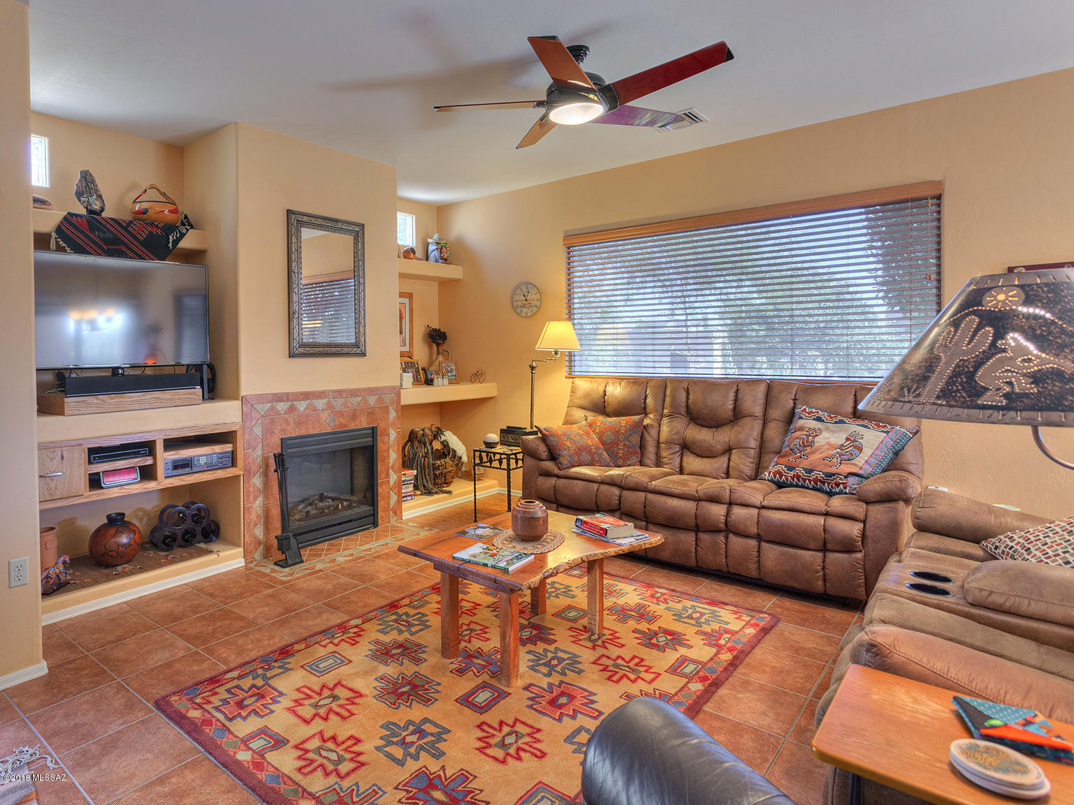 Private and spacious patio with desert plantings where you can enjoy a morning coffee at sunrise, and fabulous sunset colors reflected in the Santa Rita mountains in the evening.  Tile floors and new carpet in both bedrooms.  A surprise nook office with built-in cabinets.  Cozy up to the fireplace in the living room! So easy to maintain—its electric.  Just two streets over to one of the most popular Green Valley Recreation centers, the Springs.  Pottery studio, camera club and computer club, plus more, within this center. Now vacant, photos show furniture that is now removed.