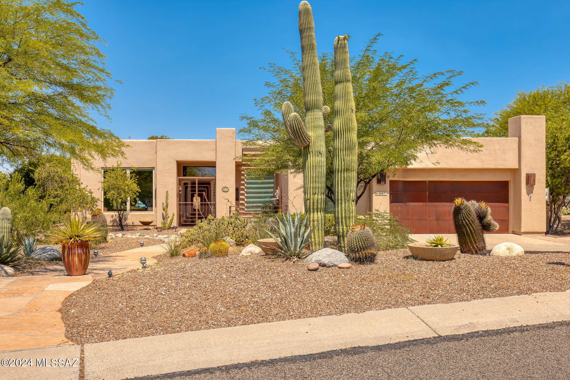 Well appointed property located in desirable Oro Valley community of Desert Vista on a large .70 acre lot. This 3 BD/2 BA/2,638 Sq.Ft home offers an inviting foyer, formal living area/den, formal dining room w/coffered ceilings & great room concept family room. Gourmet chef's kitchen features granite counters, beautiful cabinets w/pulls, island w/sink & breakfast bar, breakfast nook, SS appliances w/new oven & microwave & walk-in pantry. Primary suite has patio access w/sliding glass doors, updated bath w/jetted tub, tiled walk-in shower, separate dual vanities & walk-in closet. Guest bedrooms have added mini-split AC units & east guest bedroom has patio access to backyard. Backyard is a true oasis w/large covered patio, sparkling pool, Outdoor BBQ, fireplace, 2 ramada sitting areas (MORE ...., lush landscaping & privacy w/common area behind home. Seller added an owned solar system for lower electric bills. Garage has copper garage door, cabinets, utility sink & extended area that's great for storage