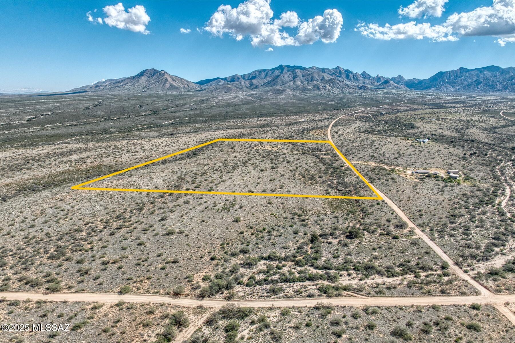 Discover the potential of this expansive 36-acre land parcel, perfectly suited for residential development in the gated Dragoon Mountain Ranch community.  Located in a peaceful, rural setting with convenient access to main roads and nearby towns, this property offers a rare combination of seclusion and accessibility.
The land features a mix of open grass fields and mature mesquite wooded areas.  Gently rolling high desert terrain, and stunning natural scenery all at 4600' elevation. This mostly level lot is ideal for building your dream home, Electricity is on the lot line along with fiber optic internet. A graded driveway for land access and a small fenced in dog run welcomes you to this amazing acreage.  A greenbelt of state land on the north border gives additional open space.