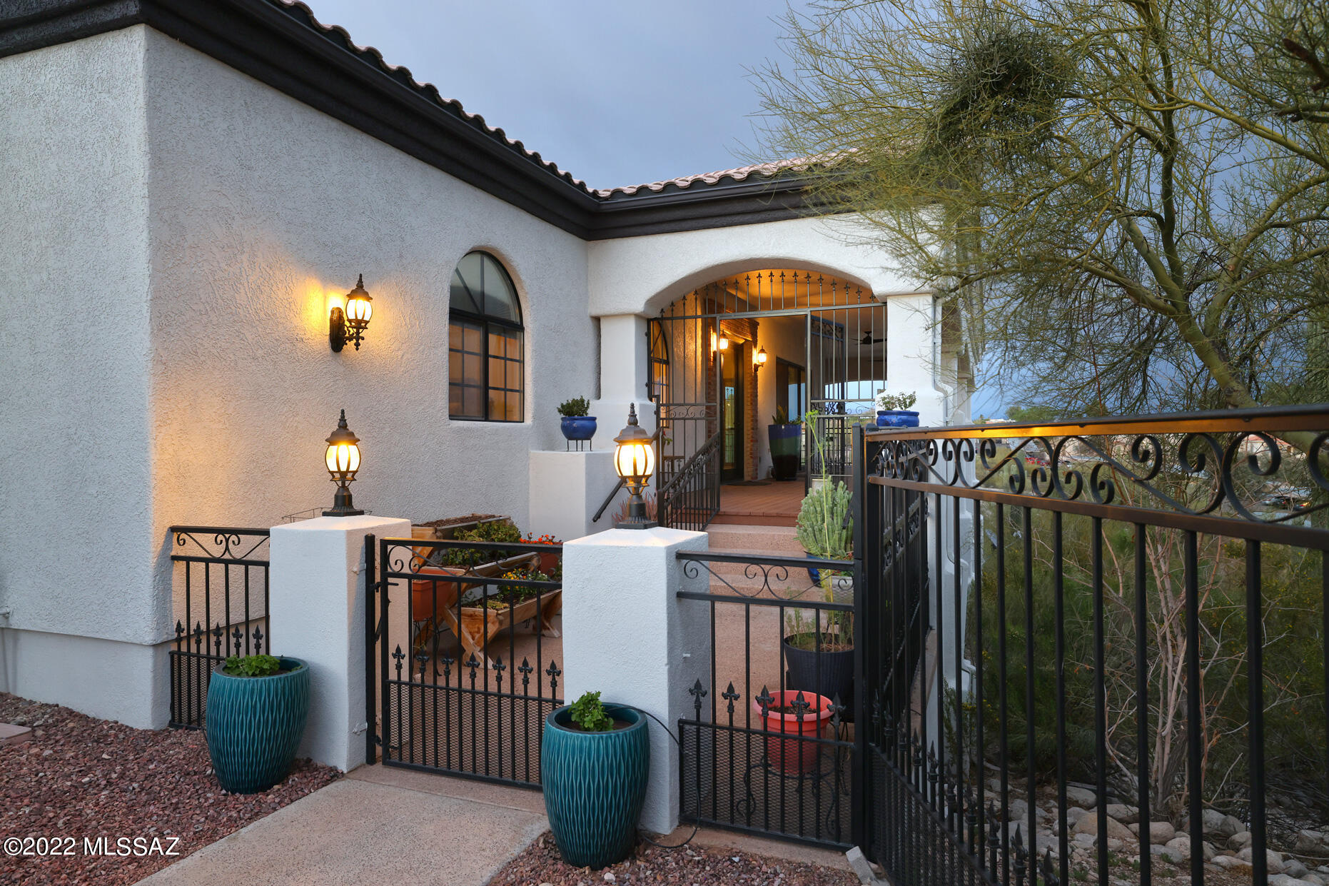 This stunning house + guest house is an entertainer's dream! Amazing city lights and views of the Catalinas are just the start. Main home offers a magnificent kitchen w/2 islands, rich cabinetry, lovely granite, fantastic bar area, 2 dishwashers & 2 sinks. Wonderful hickory flrs, exposed brick details & crown molding adds warmth and character. Let the party flow out to the huge wraparound patios & soak in those views! Mstr Ste has a generous ensuite w/dual vanities, jetted tub, walk-in shower & gym area. Fabulous 2 BR, 2 BA Gst Hse features concrete flrs, full kitchen w/SS appl, quartz counter, stylish backsplash, living & dining areas. Main house has a 3-car gar & GH has a 2.5-car gar.  Don't let the address fool you, this remarkable compound is tucked a quarter mile back from the road.