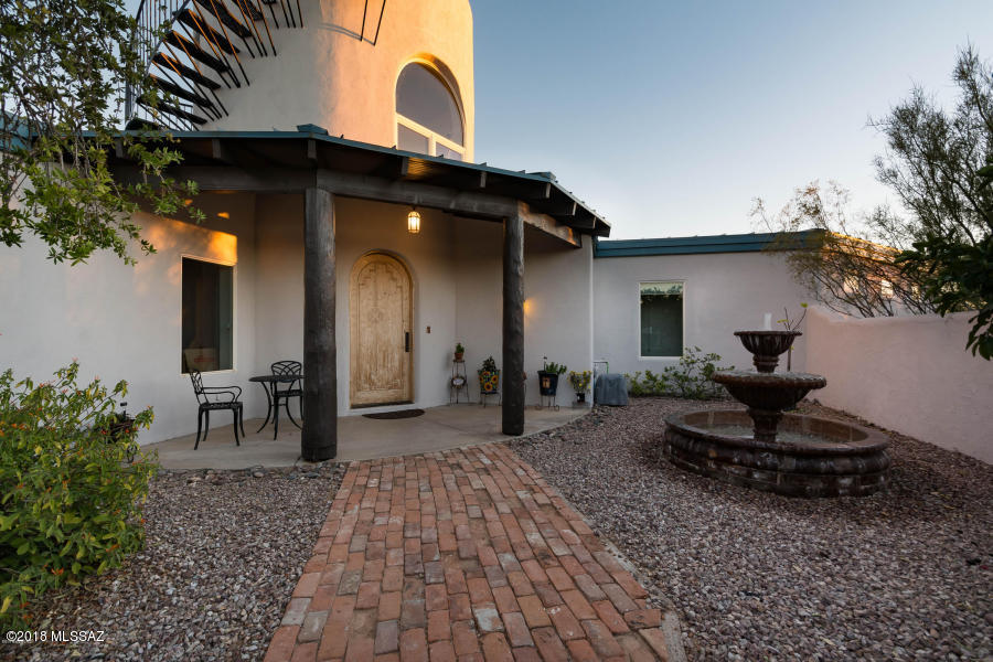 Incredible custom home on  private drive tucked 1/4 mile off Oracle Rd with Large Commercial building with 6 offices and two 15' Roll up doors.
Perfect for a contractor or extreme hobbyist. The Energy efficient ICF home boasts travertine floors, vaulted exposed beam ceilings, east facing dual pane windows throughout. Split-bed plan has den, formal dining & great rm with striking stone surround fireplace. Winding staircase off foyer leads to viewing loft & balcony that overlooks unparalleled and unobstructed views of the Catalina Mountains. Kitchen features granite, island with seating, walk-in pantry & storage. Perfect backyard for entertaining guest whether under covered patio, around the firepit, cooking by the built-in BBQ or enjoying the views! 5 Acres, 2 separate parcels.