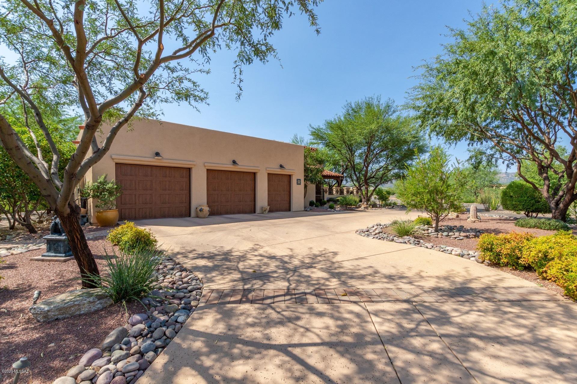 Stunning Spanish Villa surrounded by breathtaking Mountain & desert views.  Charming gated courtyard entry w/a 3 car garage. Spacious open floor plan w/a custom palette, plantation shutters, recessed lighting, beautiful tiled floors, fireplace, decorative shelves, ceiling fans, & formal dining room. Handsome wood kitchen cabinetry w/hardware, center island, upgraded lighting,  pantry, & SS appliances. Perfect home for entertaining. Private Den w/built-in cabinets & shelves. Master retreat features patio access, & Mexican tiled bath counters. Beautiful bathrooms throughout, large laundry room w/storage cabinets & sink, & epoxy garage floors. Covered patio, built-in BBQ/kitchenette, decorative fountain, & picturesque views.