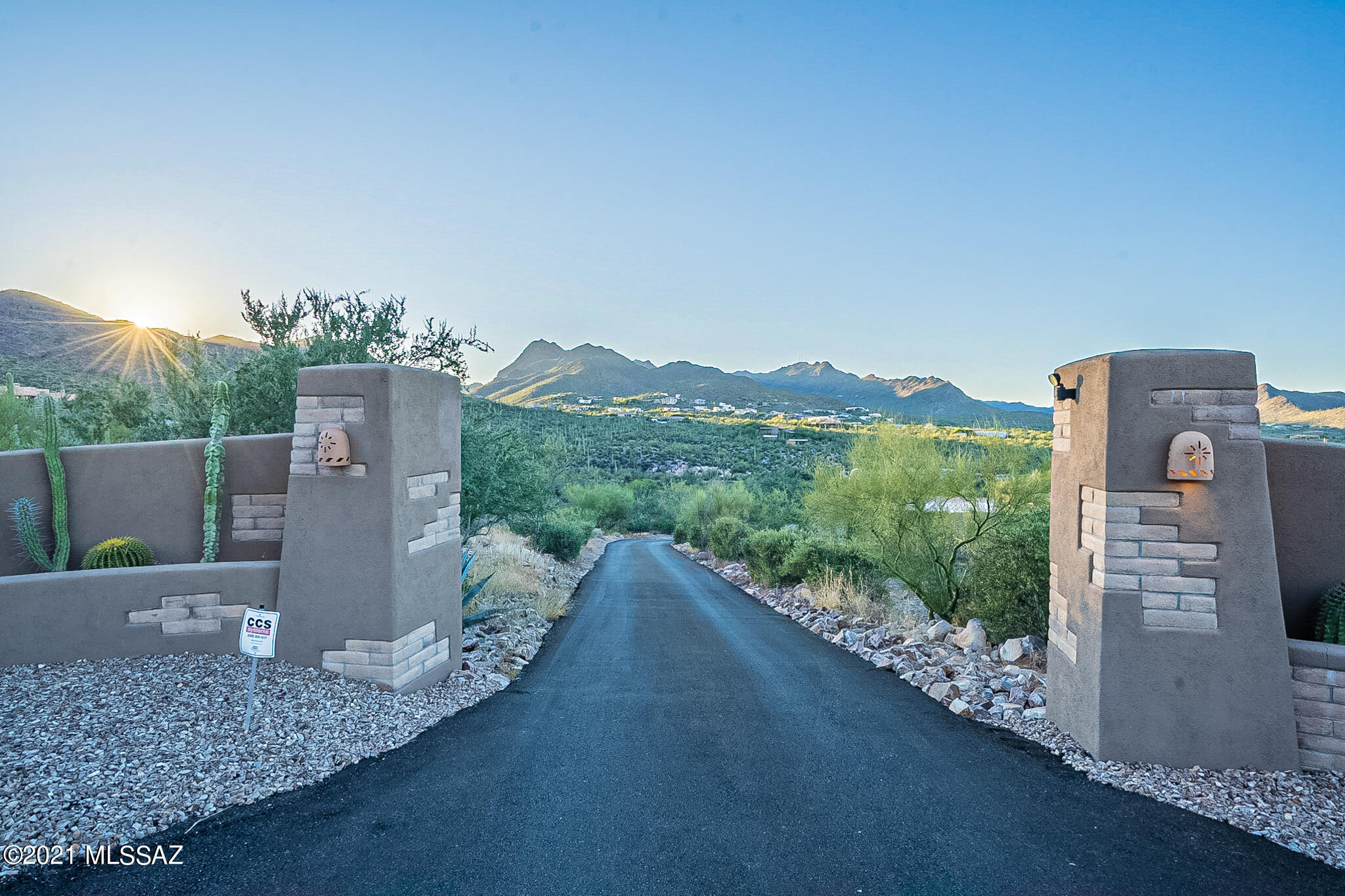 Exquisite architecture can be found in this 4bd/4ba custom built Santa Fe style home in the exclusive Twin Hills gated community. Capture the appeal of Tucson's Westside with stunning 360 views! Private driveway w/4 car garage with a 252sqft air conditioned storage space that can be used as an office. Custom entrances invite you into the foyer and sitting area w/vaulted ceilings adorned with wood beams & ceiling fans throughout. Gourmet kitchen is gorgeous with plenty of room for gathering with friends & family, subzero refrigerator . There is a intercom & surround sound throughout the home. The basement has space for a separate living area and leads right out to the pool. The pool is a 52' x 22' free form lagoon style pool with custom rock water features & a commercial sized pump system.