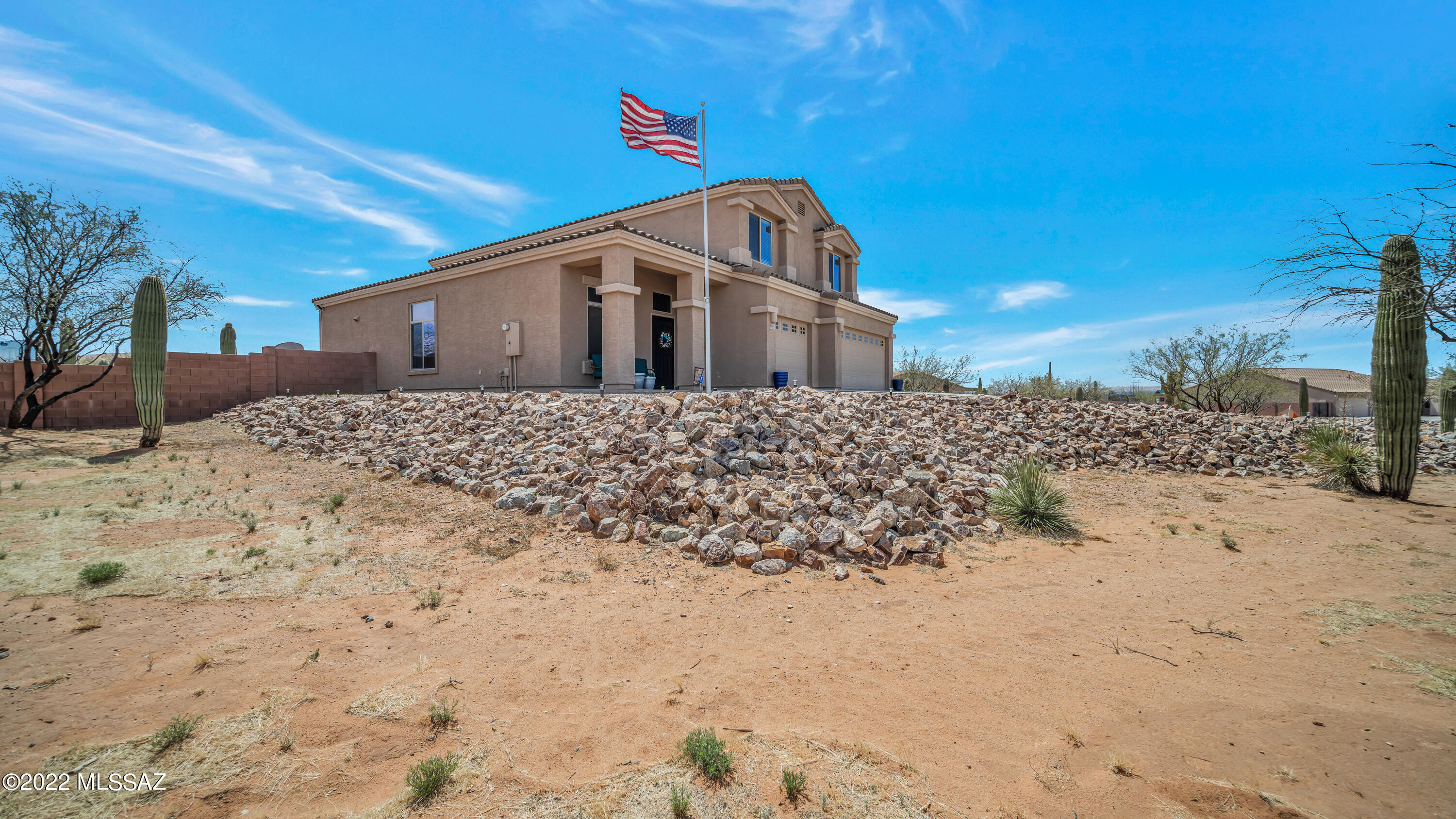 This property is in the remarkable community of Sahuarita Highlands, with acre plus sized lots and miles of off-road trails right at your fingertips. With nearly 3,185 square-feet, a three-car garage with storage, back yard paradise and one and a half acres of property, what more could you need? The long driveway greets you with large Saguaro cacti and beautiful natural desert landscaping leads you to the front entrance. Come inside to cathedral ceilings and a large seating and dining area, giving this large two-story home an open feel. The kitchen has plenty of storage space, soft close updated cabinetry and a large kitchen island, perfect for prep work and entertaining purposes. Off the kitchen is a well-appointed, spacious great room with large windows providing an abundance of... natural light and great views. Also, on the main floor, you will find a spacious bedroom and full bath.  Ascend the staircase to a large loft area and split bedroom floor plan. The expansive main retreat includes a large balcony, offering panoramic mountain views. A perfect place to enjoy the majestic morning sunrise and evening sunset the Sonoran Desert has to offer. You won't find anything missing in the amazing backyard to sit back, relax and entertain to the fullest. A large, covered patio area is perfectly situated above the heated, saltwater pool with spill over spa and waterfall featuring a grotto area. The wood burning fire pit provides fun evenings and a place to relax. But that's not all, a spacious artificial turf area, plenty of extra walled in yard space, with a 14ft access gate and a raised planter box for all your gardening needs. This is a must see, breathtaking property you won't want to miss.