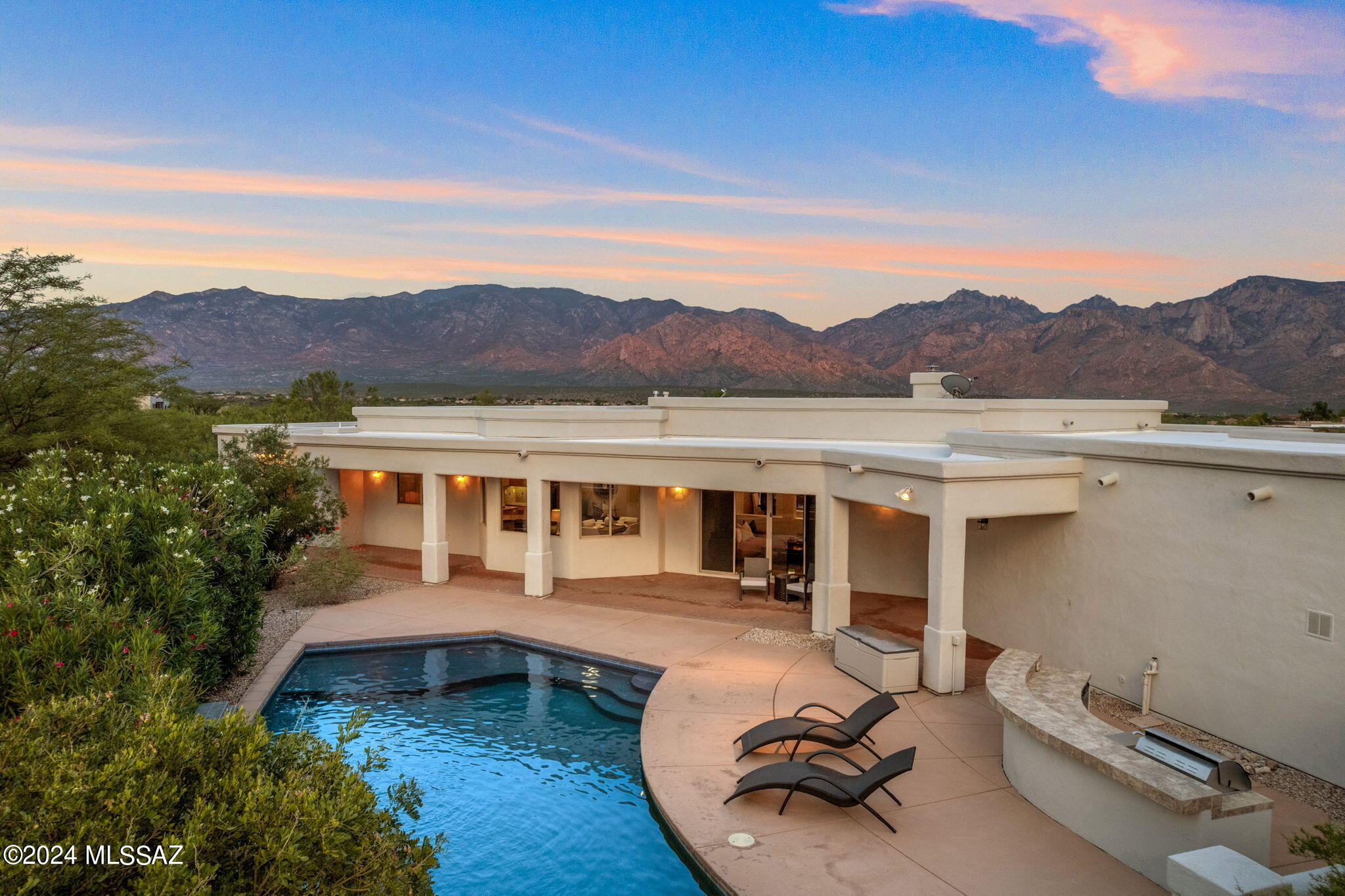 Perched on an elevated lot in gated The Estates at High Mesa in Oro Valley's Master Planned Community of Rancho Vistoso, your Desert Dream Home awaits. Featuring front row seats to the most coveted and unparalleled views of the entire Catalina Mountain range, Pusch Ridge and the valley beyond to the East, this elegant and airy abode boasts all the areas you have dreamed of.Under 3512 sq ft of absolute beauty, you will find 4 bedrooms, 3 full bathrooms, a grand entry foyer, dual living and dining areas, an office- all in a fluid and functional floor plan. Simply mesmerizing views from all windows as you make your way around all of your new home's inviting spaces. A fresh and gated courtyard welcomes you to an impressive glass entry doorway and grand foyer. High ceilings, neutral palette and open spaces set the mood for a comfortable yet elevated living experience.
Spacious dining area, den or living room, office with a wall of drawers/shelves,  family room with niches and gas fireplace, roomy breakfast nook and a Chef's kitchen that is sure to please. Custom wood cabinetry, granite countertops, gas cooktop, wall oven/microwave, desk area, double sink, pull-out drawers are some of the features found in your delightful kitchen. So much space to wander and decorate to your hearts' content. As you flow from room to room you cannot escape the imposing VIEWS as the window- clad areas effortlessly bring the outside in. Vast Primary en-suite with seating area, walk-in closet with custom cabinetry, dual vanities, jetted tub and shower to complete the spa-like feel. Split floor plan (threes zones) offers privacy. Bedroom 2 features a hall bath which also functions as your guest wing. Bedrooms 3 and 4 share a Jack-n-Jill bathroom with double vanity. All are bright and spacious plus offer views as well. Your backyard showcases a salt water pool with modern water feature, a grill/bar area and space galore to host amazing gatherings or relax and unwind. Roomy 2-car garage has fresh paint and new epoxy floor. Home's exterior was painted last year. Roof re-coated in in 2023. The epitome of luxury living in Oro Valley is here for you in this gorgeous Soft Contemporary home and its community. Top notch entertainment, shopping, hospital, hiking, biking paths, outdoor living to the max!