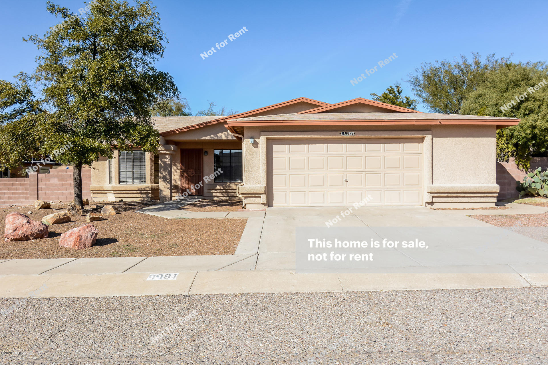This Tucson one-story home offers stainless steel appliances, granite tile counters, a covered back patio, and a two-car garage.