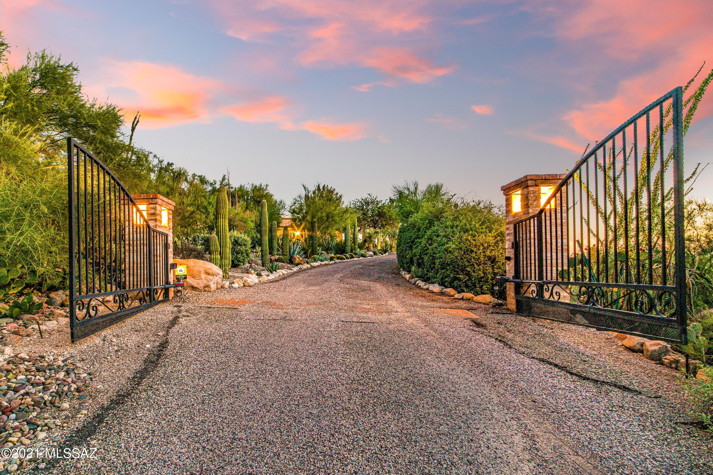 Seldom does a property of this magnitude become available in the heart of the ''Old Foothills''. The original Joesler Estate dates back to 1943, with updated modern amenities added throughout. Privately gated, this one-of-a-kind property sits on a 5.28 acre ridgetop with 360 panoramic views. The main home is a comfortable 4,480 Sq Ft and has 3 bedrooms (office can be converted to 4th bedroom), 3 bathrooms, formal dining room, family room, living room and private offices. The master suite has its own wing, while the exquisite open to reveal an expansive wing with updated bathroom, his + her toilets/bidet, large closet, office & sitting area, and direct access to the front and back patios. Kitchen has Viking and Sub Zero appliances, incredible architectural details and enormous additional additional storage. Natural light and views from nearly every room with Joesler character and details throughout. The newer Guest House is a spacious 726 Sq Ft and has 1 bedroom, 1 bathroom, living room and kitchenette. Both private and comfortable, the Guest House is a fantastic option for long or short term guests, extended family or private office quarters. Lap pool, outdoor living room/ramada, city views, rooftop deck and endless outdoor private retreat areas. The estate is privately situated on 5.28 acres of desert beauty, views and natural surroundings, yet only a few minutes from the University, Joesler Village, La Encantada, restaurants and The Rillito River Park Trail. Opportunity for potential lot split and development.