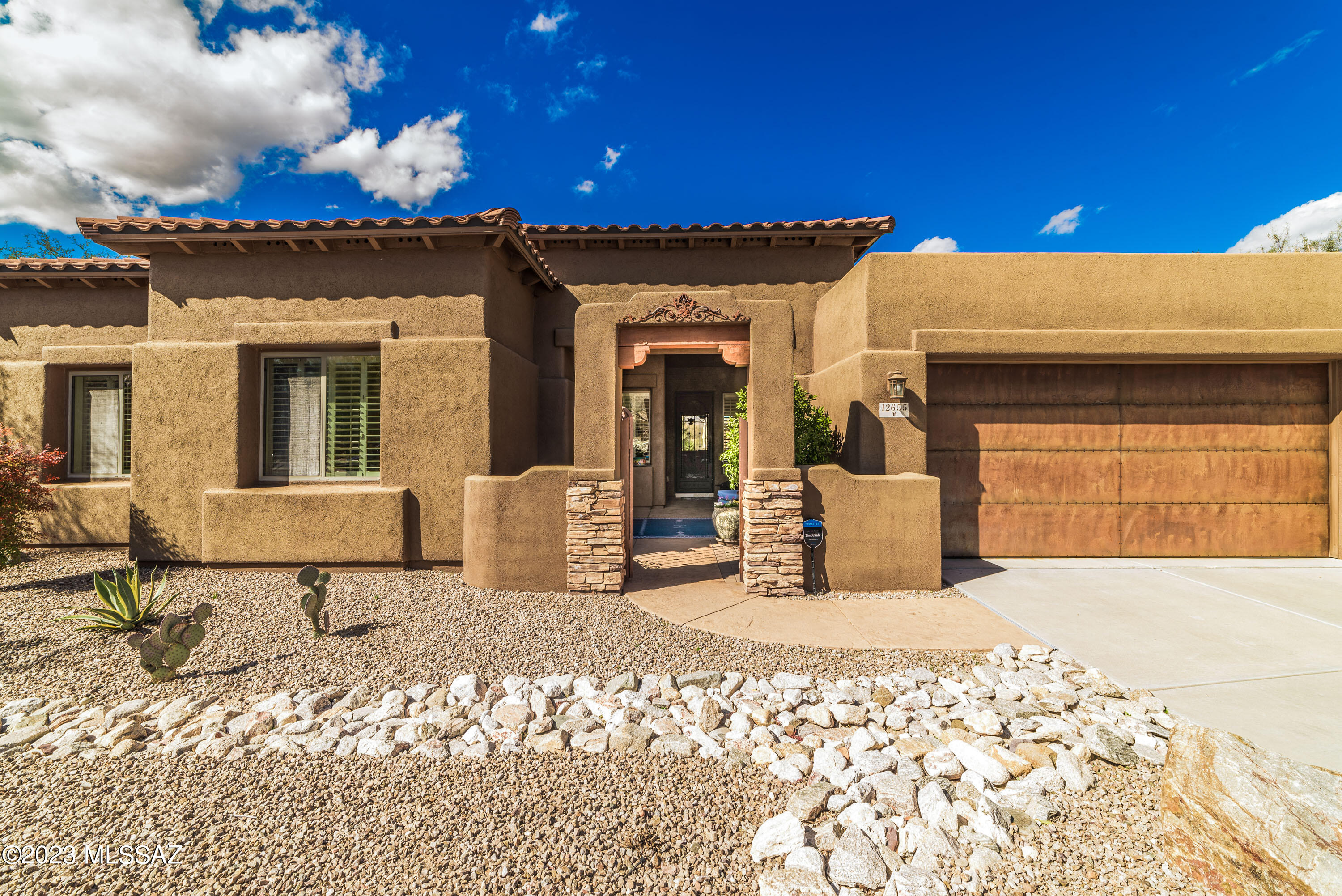 Spectacular 3540 SF home with 5BD/3BA in desirable Vistoso Highlands.  Open Concept Floor Plan! Enjoy the decorative fountain located in gated courtyard along with glorious flowers/plants in decorative pots as you enter this gorgeous home. Great room provides added relaxation with a newly installed fireplace. Gourmet kitchen offers SS appliances, granite counter tops, double ovens, island and breakfast bar. Master suite has large walk-in closet, soaking tub & walk-in shower. Enjoy the mountain and sunset views from your resort style yard while relaxing in the pebble-tec pool/spa. The outdoor oasis continues with an outdoor kitchen, citrus trees, beautiful potted plants & park-like path just below. Home is very clean and well-maintained. Home warranty is included!