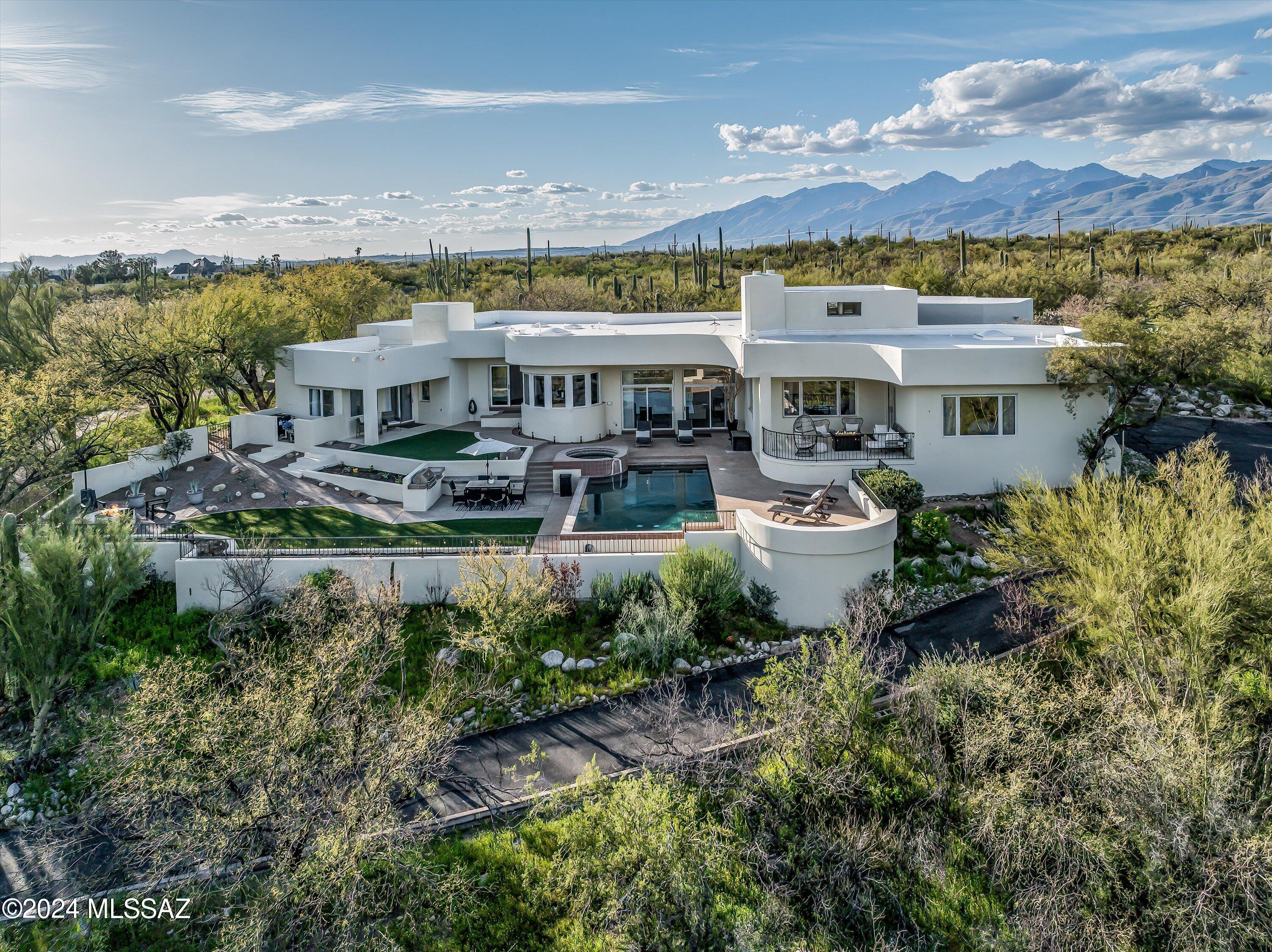 SELLER WILL COUNTER OR ACCEPT OFFERS BETWEEN $1,450,000-1,500,000. Luxurious Desert Living in Coveted La Cebadilla Estates! Discover elegance and sophistication in this contemporary residence nestled within the esteemed La Cebadilla Estates, offering a sprawling 3.6-acre oasis of desert serenity. Surrounded by majestic saguaro-studded mountains and panoramic views, this elevated lot provides the ultimate escape amidst wide-open spaces and endless natural beauty. Enjoy resort-style living with a sparkling Pebble- Tec pool, cascading spa, and cool covered patio—perfect for entertaining. Unwind against the backdrop of sunset skies from the outdoor pergola or cozy up to the outdoor firepit. Enter through the grand foyer and be captivated by soaring ceilings, an elegant chandelier, and... unique architectural features. Light and bright, the living spaces are well defined, including a formal living room with a fireplace, separate family room and formal dining area. The chef's kitchen features a gas cooktop, Subzero refrigerator, quartz countertops, and jaw-dropping views from the breakfast nook. Escape to the primary suite where relaxation begins! Enjoy your coffee and sunrise from the adjacent patio and then retreat to the spa-like primary bathroom, which boasts a garden tub, dual vanities, and two huge walk-in closets. With four bedrooms, three and a half bathrooms, plus an office/den, this home offers ample space! A thoughtfully designed split floor plan with guest quarters, ensures privacy and comfort for all. Additional features, such as tile flooring throughout, modern ceiling fans, and an epoxy-coated three-car garage with ample storage, this home seamlessly blends luxury and practicality for the discerning buyer. Zoned for horses, with access to nearby horse trails and washes, hiking and biking trails, neighborhood lake, golf courses, and a stone's throw from Saguaro National Park East! Immerse yourself in the beauty of the Arizona landscape and call this your new home!