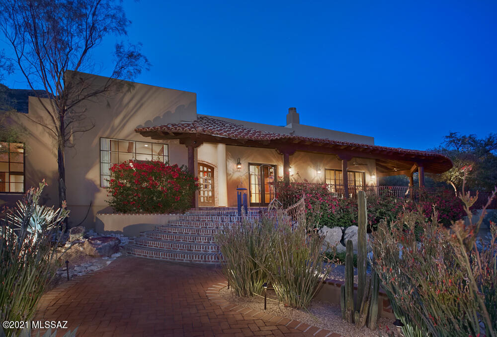 One of The Foothills finest homes in gated Skyline Country Club Estates is now up for sale and is better than ever before! Having spared no expense in the recent renovation, the current owners have updated, upgraded and turned this stunning 2006 Old World Spanish Hacienda into a magnificent and timeless work of art. As you approach the home which is situated perfectly on a large corner view lot with mature vegetation, you are greeted by a pedestrian bridge with antique iron accents that lead you over the arroyo to the front entry. Antique bricks and custom wrought iron handrails lead you to the custom alder and glass front door. Walking in your eyes are immediately drawn up to the towering Catalina Mountains that are perfectly framed by windows in the living room, kitchen and breakfast nook. The great room/living room is the heart of the home w/a stacked stone fireplace, flat screen tv, high beamed ceilings and leads to the absolutely beautiful chefs kitchen and casual dining area with 18'windows to capture the impressive views. Finished with alder wood cabinets and a contrasting island, granite counters and backsplash, top of the line Viking, Sub Zero & Fisher Paykel appliances, a pot filler over the gas cooktop, walk in pantry & wine cooler, this kitchen will be the envy of all your friends and family for years to come and will be your happy place when home preparing meals.  The formal dining room sits at the front of the house to capitalize on the city lights and also features a large picture window, a gas fireplace and high beamed ceilings. The lavish master suite is outfitted with a gas fireplace, wall of sliders to access the patio and capture the city view at night, a large walk in closet & a spa like bathroom w/jetted tub, two vanities and a walk in shower. Two en-suite guest bedrooms w/private baths, and two additional bedrooms that share a Jack N Jill bathroom w/private entrances and are currently being used as an office and exercise room.  Just off the master suite is a library/music room/home office with custom built ins and room for a grand piano. To experience the true Arizona lifestyle, you will appreciate the sparkling pebbletec pool and waterfall in the backyard and the expansive wrap around covered patio with Rogo's colored concrete floors in the front ideal for watching summer monsoon storms roll in across the desert. Oversized three car garage w/new openers, storage throughout, mature desert landscaping, updated mechanical systems (replaced one of two HVAC, replaced hot water heater with tankless system, smooth finish stucco, recoated roof (2020), epoxy garage floor & ample off street parking for entertaining. This home is in excellent condition in one of Tucson's premier communities and will not last.