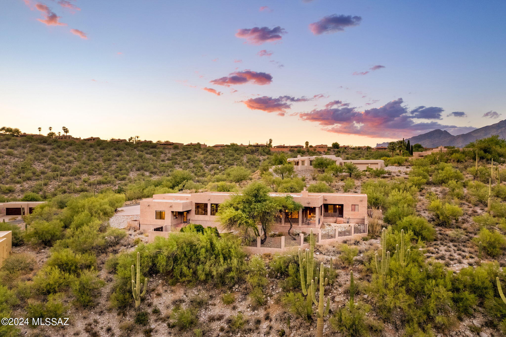 Located in a quiet gated community and at the end of a secluded cul-de-sac, this exquisite Catalina Foothills residence is the perfect home for those seeking unparalleled privacy and tranquility. With 3,150 sq. ft. of beautifully designed living space, this home features 3 bedrooms, a dedicated office/den, & 2.5 bathrooms, providing ample room for relaxation and productivity. 

Enjoy stunning mountain and city views through expansive picture windows in the family room, complete with electronic window shades for your convenience. The family room blends seamlessly with the beautiful kitchen which boasts a Viking four-burner gas cooktop, granite countertops and backsplash, & dual sinks, perfect for culinary enthusiasts. Gorgeous scored concrete floors flow throughout the living areas adding a touch of elegance and durability.

The east-facing backyard ensures optimal sun exposure and has one of the largest covered patios you'll find, and is complete with a built-in Viking barbecue. The low-care backyard is perfect for entertaining and enjoying Arizona's beautiful weather. Benefit from one brand-new AC unit and furnace, ensuring year-round comfort. Located close to Tucson's best shopping and dining, this home truly offers a unique blend of convenience and privacy.
