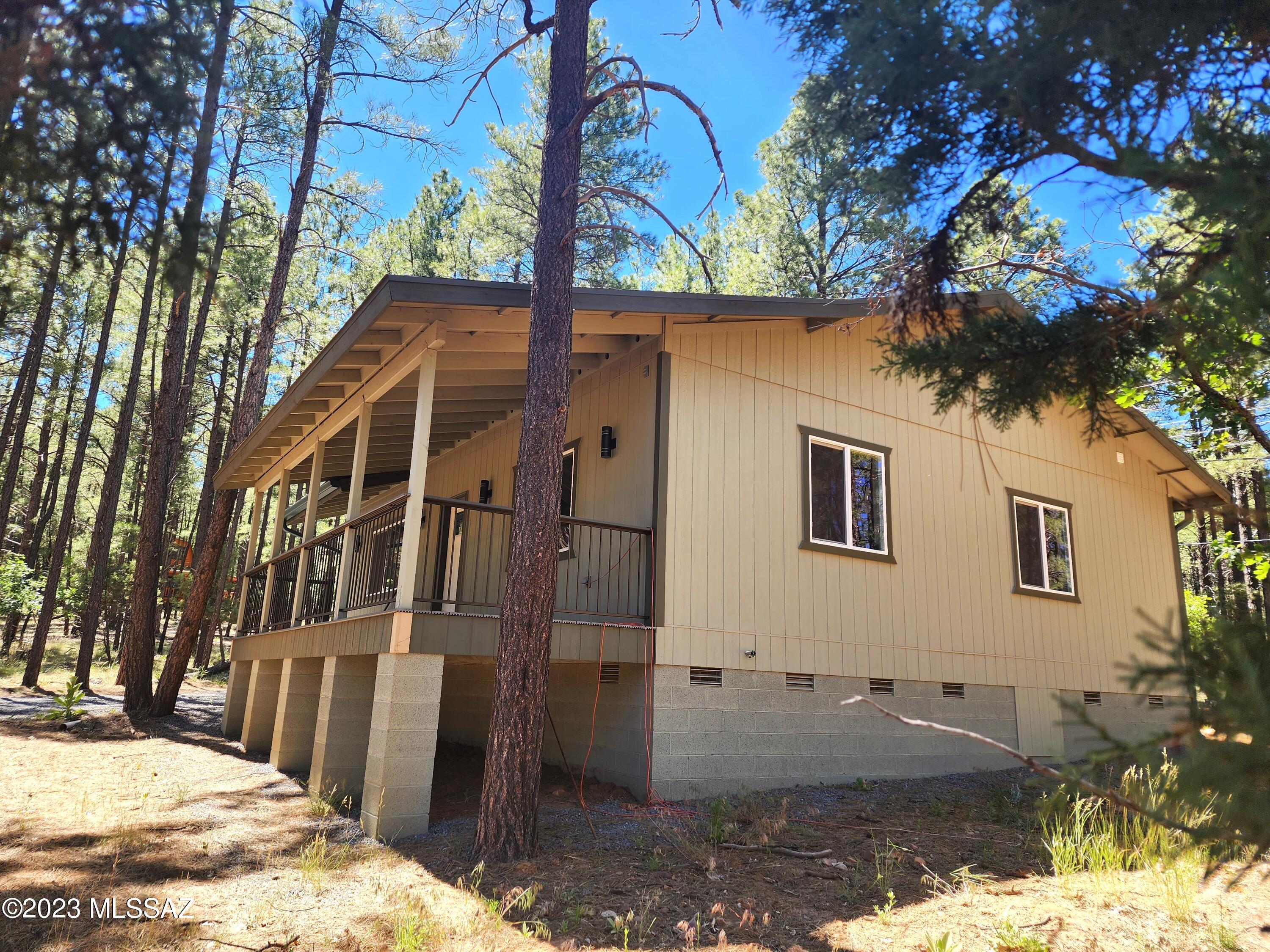 This modern cabin offers a tranquil escape, allowing you to immerse yourself in the beauty of the natural surroundings. Situated amidst a picturesque landscape, the cabin is nestled in the heart of a lush forest. Towering pine trees, majestic oaks, and graceful aspens create a harmonious backdrop, offering both shade and a sense of serenity. The air is crisp and filled with the soothing scents of the woods, enhancing the peaceful ambiance. As you approach the cabin, you'll notice the meticulous craftsmanship of its newly built design. The cabin is strategically positioned to offer panoramic views of the surrounding wilderness. Stepping inside, you're greeted by an open and inviting floor plan, designed to maximize both comfort and functionality. The spacious living area features large