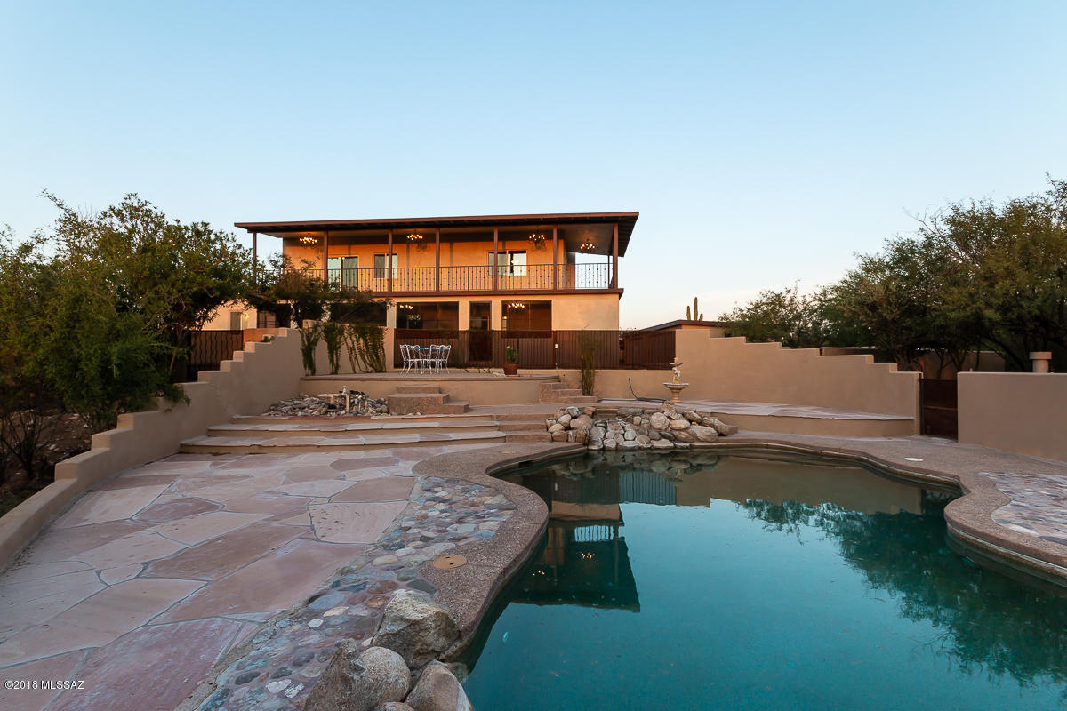 REDUCED TO VALUE OF THE RECENT APPRAISAL. Amazing 360 panoramic mountain range & canyon views around this private 5 acre fenced in & gated horse property. Entire property has been extensively renovated in 2018. 4 car garage in addition to 2 carport spaces & workshop.  Sparkling heated pool and spa, all newer stainless steal appliances in main kitchen. Main house with 4 bed 3 bath and 2 fireplaces.  Maple wood flooring was treated exclusively with ecological sealers (child and pet friendly, completely natural). Guest area with bath and kitchenette and private  entrance. Two front porches offer sunrise views of the Rincon peaks, one closed in back porch with views of the sunsets and distant views of the city lights. Travertine tile throughout the living spaces and refurbished hardwood floors