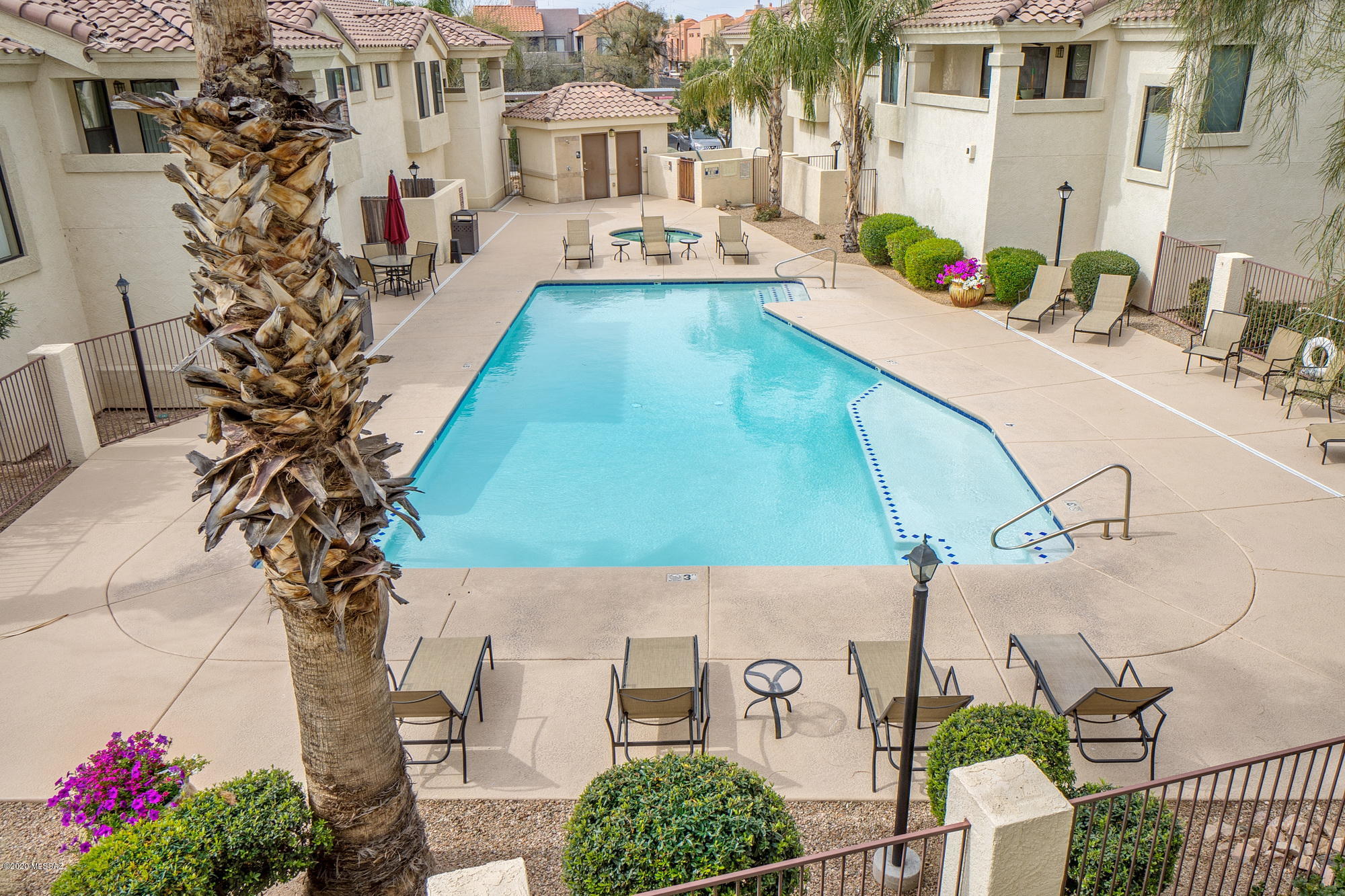 Come and see this hip loft style condo with a garage! Large patio overlooks the pool & spa.  Granite countertops, stainless appliances and cherry cabinets.  Laminate flooring throughout. Beautiful mountain views! This community is located at the heart of the foothills. Enjoy shopping and fine dining just steps away from your front door, or take a walk or ride on the Rillito River from your private entrance. This exclusive gated community has resort style amenities including 2 pools, spas & fitness center.