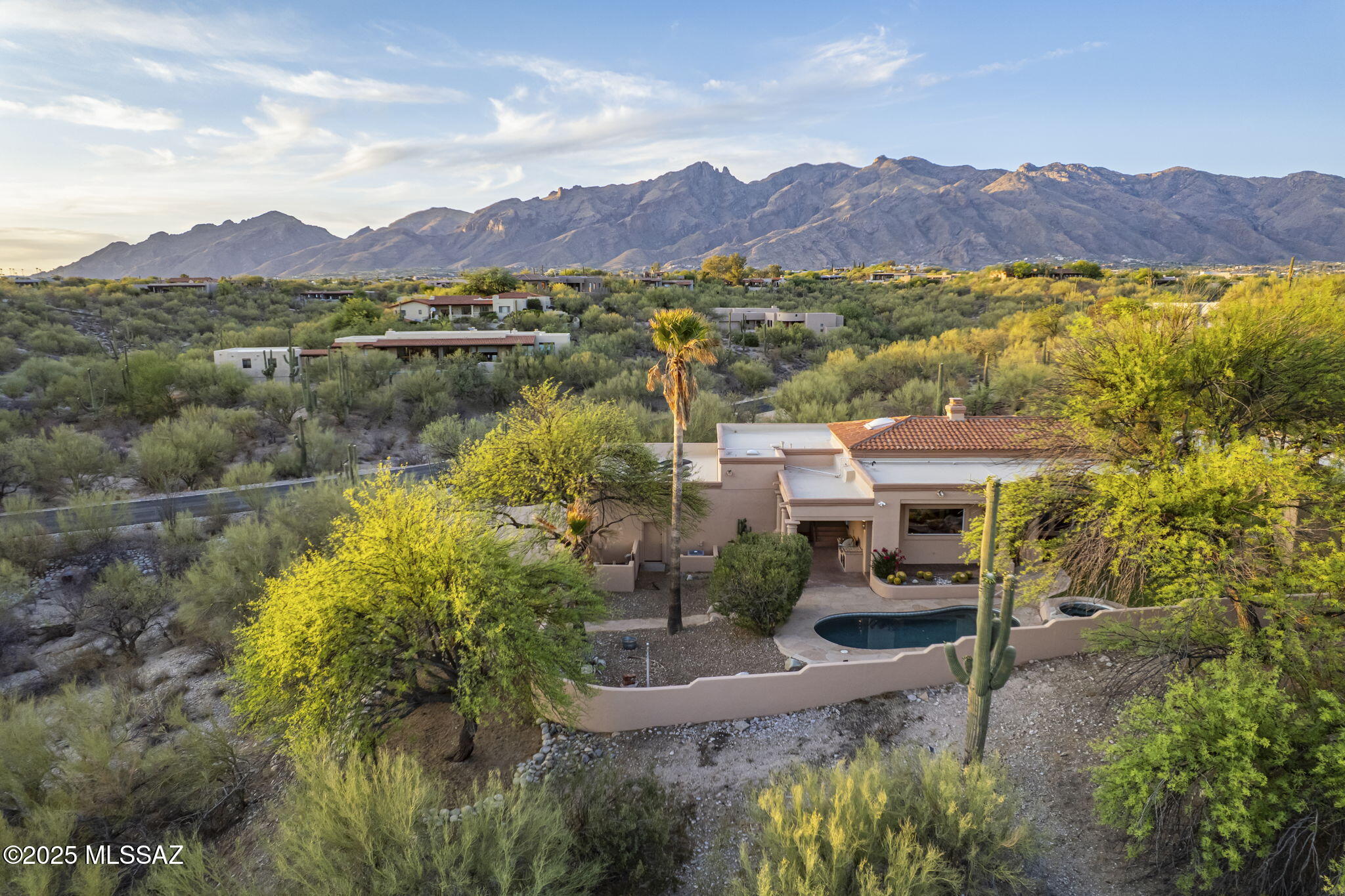 This stunning 4-bedroom, 4-bathroom estate is perfectly sited for privacy and views in prestigious, gated Catalina Foothills Estates #10.  Elegance blends with exceptional craftsmanship and artesian features throughout.  3 impressive natural stone fireplaces, expansive walls of windows, soaring 14' ceilings, and generous LED lighting guaranteed to delight any art lover all add to this home's gracious ambience.   The custom gourmet chef's kitchen offers extensive prep and cooking areas, wrapped by a large window overlooking the tranquil pool and spa and city beyond.  An inviting circular breakfast bar, 5 burner cook top, subzero refrigerator, double ovens, additional refrigerated drawers, and numerous designer elements create a kitchen that is convenient as well as functional. The spacious primary bedroom, a serene retreat with fireplace and sitting area, boasts a generous walk-in closet and French doors leading out to a secluded covered patio. The spa-style bathroom is exquisitely designed with separate vanities, a curved walk-through shower and jetted soaking tub. An additional bedroom has its own en-suite with large shower and mountain views. The French doors in bedroom 3 can open to the family room, making it ideal as an office or game room. Bedroom 4 shares a well-designed adjoining bathroom with bedroom 3. Just past the family room, the lovely powder room has a soothing Zen like appeal with carved wood and copper elements. A huge laundry room offers extra space for wine storage, hobbies, or special projects, all with natural light from the door leading out to backyard. High ceilings in the oversized 3 car garage provide for extra storage and room for all your toys!  Enjoy the breathtaking lavenders of the mountains above from dual entry patio nooks, and the meandering turf yard with sweeping city lights from the wonderfully relaxing back patio.

Home Features:
STUNNING ELEVATED VIEW LOT ON 1.89 AC
DETAILED CRAFTMANSHIP AND ARTESIAN DESIGN
MASTERFULLY DESIGNED CUSTOM NATURAL STONE FIREPLACES IN THE LIVING ROOM,
FAMILY ROOM AND OWNERS SUITE.
SOARING 14 ft CEILINGS
EXPANSIVE WINDOWS AND SLIDERS
ENERGY EFFICIENT LED LIGHTING THROUGHOUT DESIGN TO HIGHLIGHT THE MOST
DISCERNING ART COLLECTIONS
CUSTOM CHEF'S GOURMET KITCHEN WITH STATE-OF-THE-ART APPLIANCES, DOUBLE
OVEN, SUBZERO REFRIDGERATOR, FREEZER AND BUILT IN REFRIDERATOR CRISPER
DRAWERS, 5 BURNER COOK TOP WITH DOWNDRAFT FAN, PULL OUT CABINET DRAWERS,
CUSTOM DESIGNED KITCHEN ISLAND WITH STUNNING CRYSTAL PEDANT LIGHTING ABOVE
THE CUSTOM GLASS CURVERED BREAKFAST BAR.
ENTIRE HOME OFFERS WATER FILTRATION SYSTEM WITH ADDITIONAL FILTERED SYSTEM
UNDER THE KITCHEN SINK
CENTRAL VAC
SPACIOUS OWNERS SUITES RETREAT WITH NATURAL STONE FIREPLACE, SITTING AREA,
SPACIOUS WALK-IN CLOSET, FRENCH DOORS LEADING TO THE PRIVATE BACK PATIO AND
LUSH BACK YARD
OWNERS BATHROOM SUITE OFFERS LUXURIOUS SPA LIKE DESIGN WITH CURVERED
AROUND SHOWER, INDIVDUAL VANITIES, JETTED SOAKING TUB, HEATED FLOORING, WALKIN
CLOSET
GUEST BEDROOM #1 OFFERS AN ENSUITE WITH BEAUTIFUL ACCESS LIGHTING AND WALK
IN SHOWER
THE FAMILY ROOM IS ADJACENT TO THE KITCHEN WITH AN INTRIGUINGLY BEAUTIFUL
ARTESAN FIREPLACE AS A CONVERSATION PIECE
THE POWDER ROOM OFFERS A SOOTHING ZEN LIKE APPEAL WITH CARVED WOOD AND
COPPER ELEMENTS
GUEST BEDROOMS 3 AND 4 ARE WELL DESIGNED WITH CUSTOM DESIGNED ADJOINING
BATHROOM.
A TRANQUIL AND RELAXING BACKYARD WITH SOLAR HEATED POOL AND SPA TO ENJOY THE
TWINKLE LIGHTS OF THE CITY AND THE MAJESTIC MOUTAIN VIEWS
EXPANSIVE 3 CAR GARAGE WITH EXPOXY FLOOR AND EXTENSIVE STORAGE
LARGE LAUNDRY ROOM WITH SPACE FOR WINE STORAGE, HOBBIES OR SPECIAL PROJECTS
2 HOT WATER HEATERS: ONE 40 GALLON IN THE LAUNDRY ROOM THE OTHER ONE IS
TANKLESS ON THE EASTSIDE OF THE HOUSE IN THE UTILITY CLOSET
2 AC UNIT WITH ONE ON THE EAST SIDE OF THE PROPERTY AND OTHER ON THE WEST
ROOF WAS RECOATED NOVEMBER 2024
TRASH COLLECTION BY WASTE MANAGEMENT WITH A SERVICE TO RETREIVE BINS TWICE A
WEEK.
SEPTIC TANK ON THE WEST SIDE OF THE PROPERTY SOUTH OF THE AC UNIT
