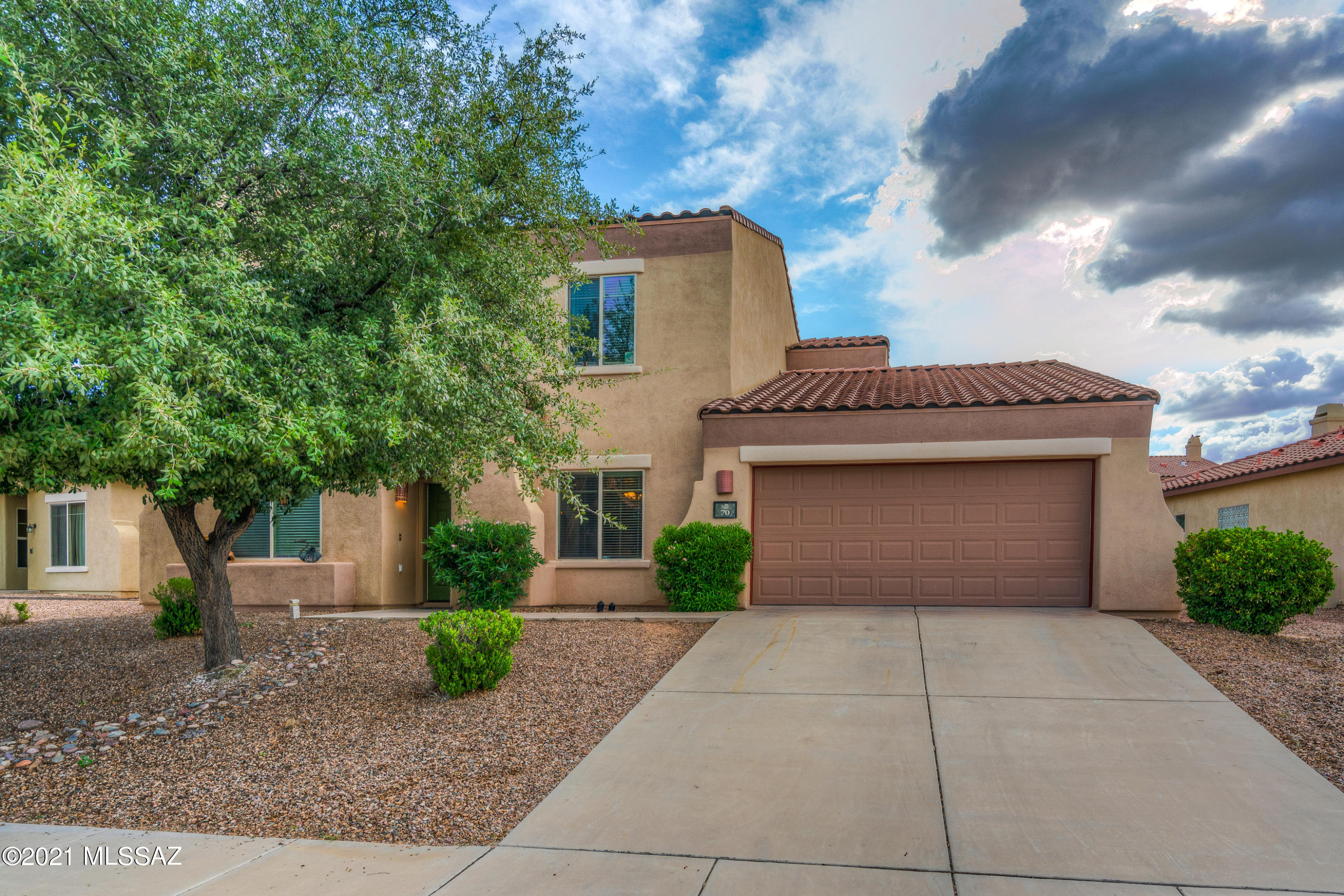 This nicely appointed home features a gas fireplace, Master bath has tile, surround sound, spa tub and  balcony off master bedroom. This home has a formal living room, formal dining room separate from the all open family room, informal eating area and a large kitchen with island and upgraded cabinets. Master bedroom & bath, three bedrooms and another full bath upstairs with a half bath, laundry room and 3 car tandem garage on the bottom floor. Large back yard with grass, trees and mature plants. All of this in sought after Rancho Sahuarita.